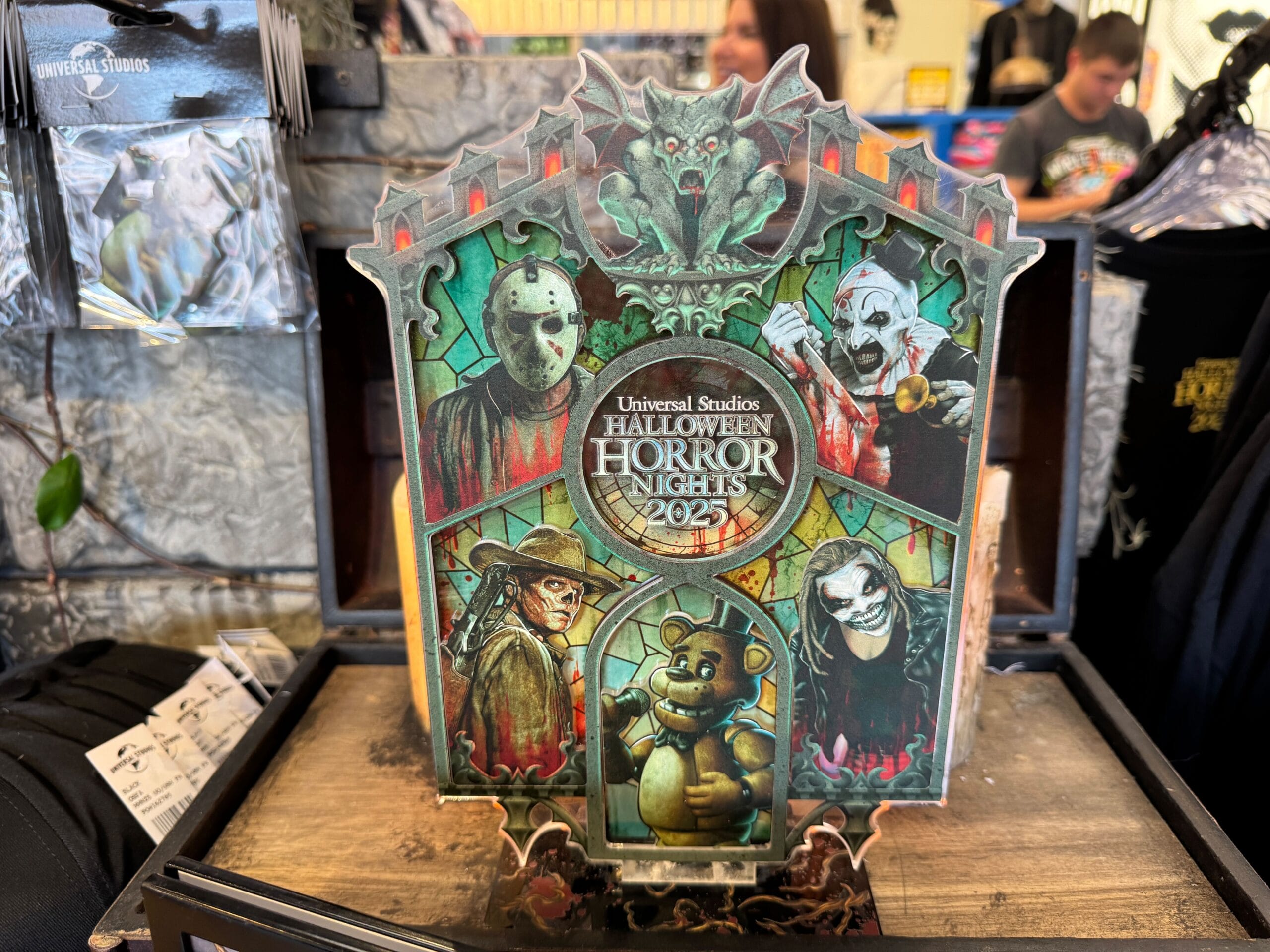 Universal Studios Halloween Horror Nights 2023 sign with horror characters, including a bear and masked figures.