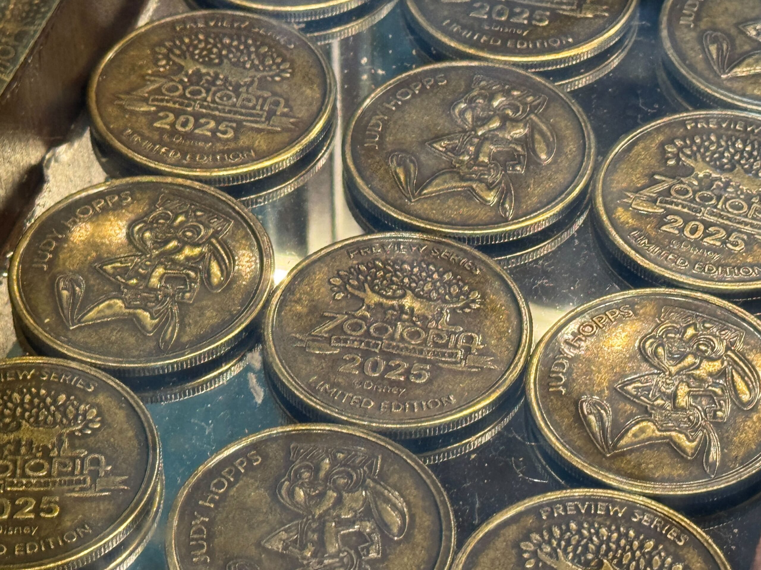 Stacks of collectible medallions featuring Judy Hopps from Zootopia, labeled "2025 Preview Series Limited Edition.