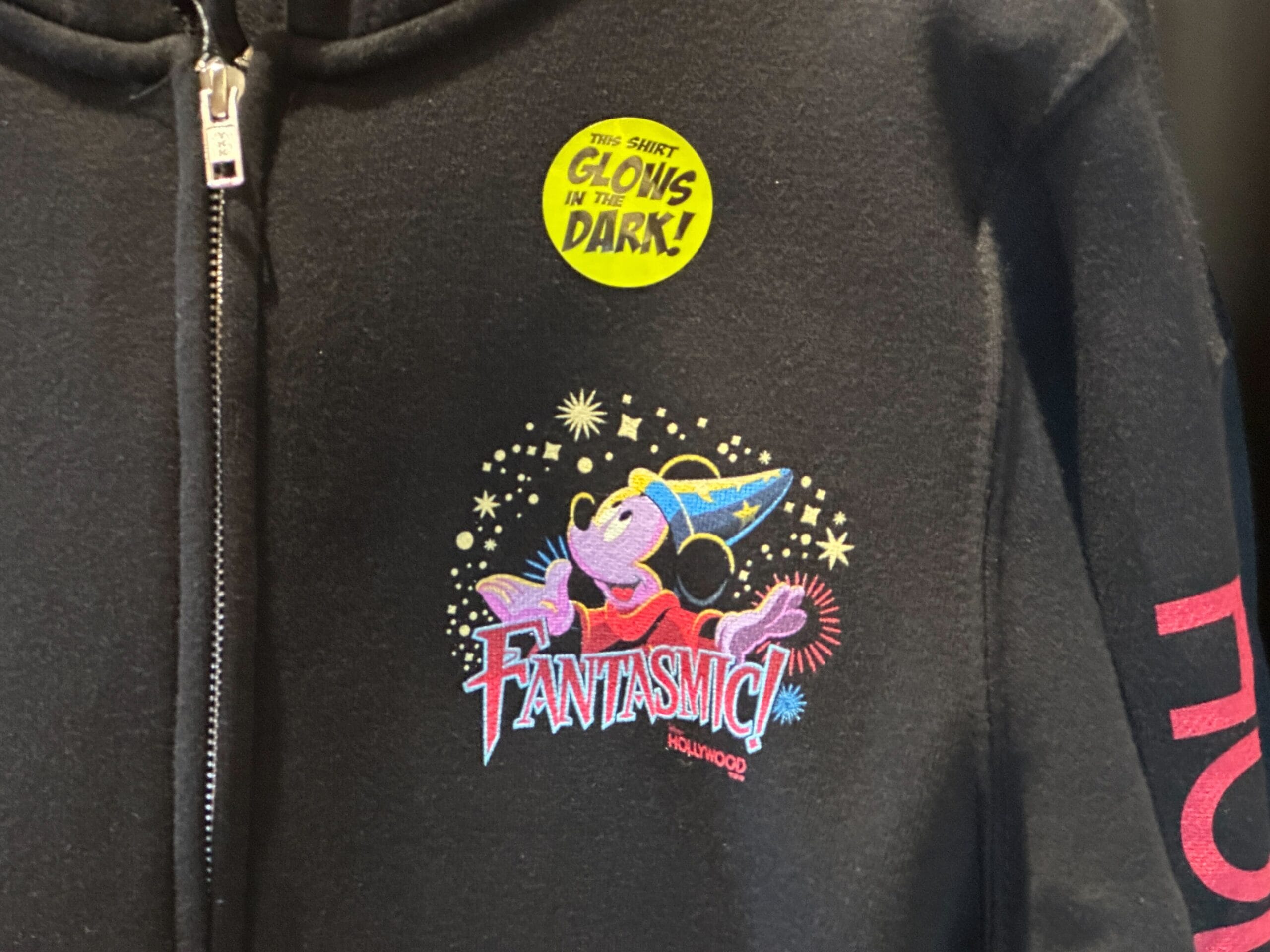 Black hoodie with Fantasmic! Hollywood design featuring Mickey Mouse in a wizard hat and a "Glows in the Dark!" sticker.