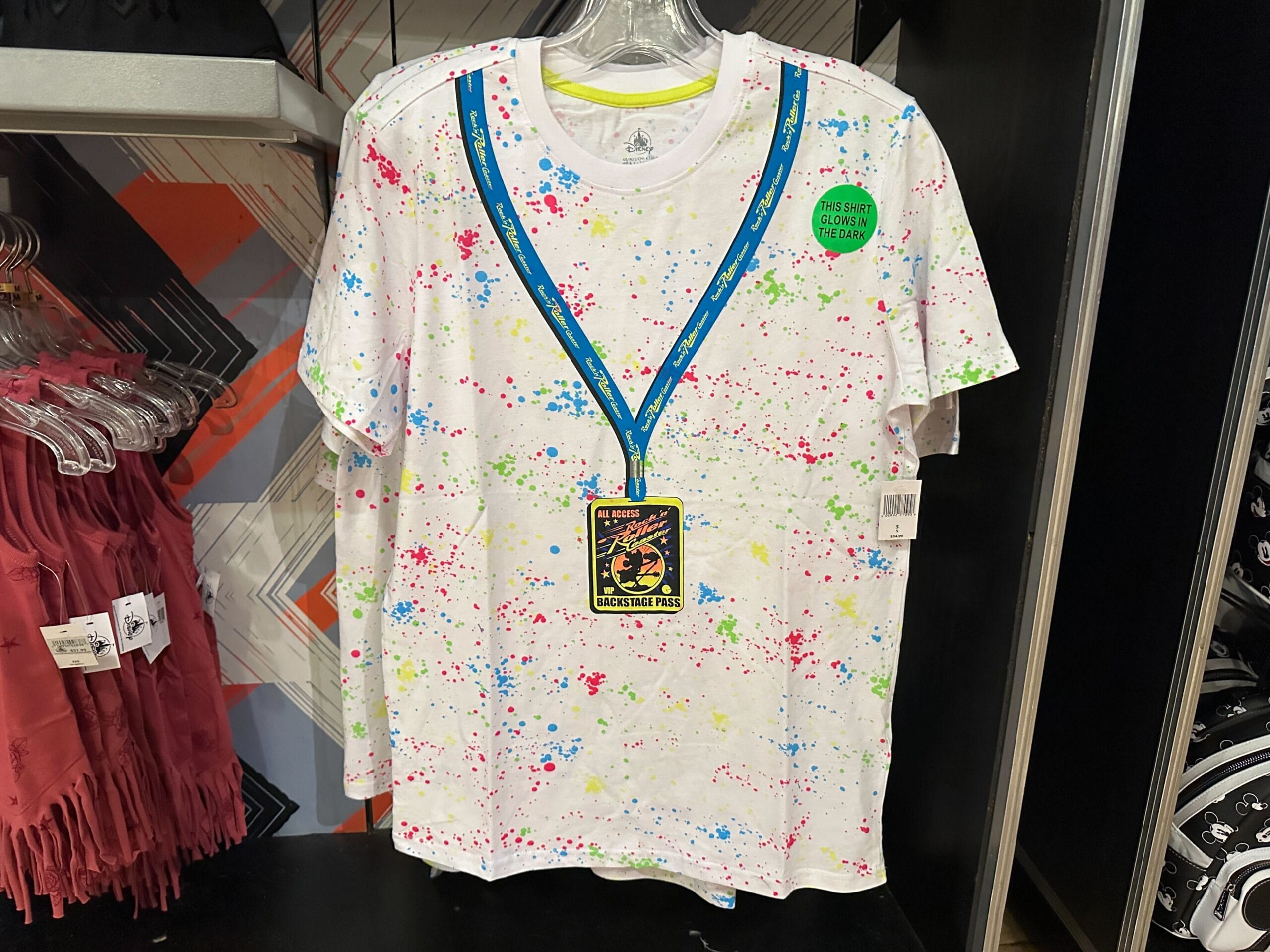 White T-shirt with colorful paint splatters and Rock 'n' Roller Coaster graphic, new merch at Disney's Hollywood Studios.