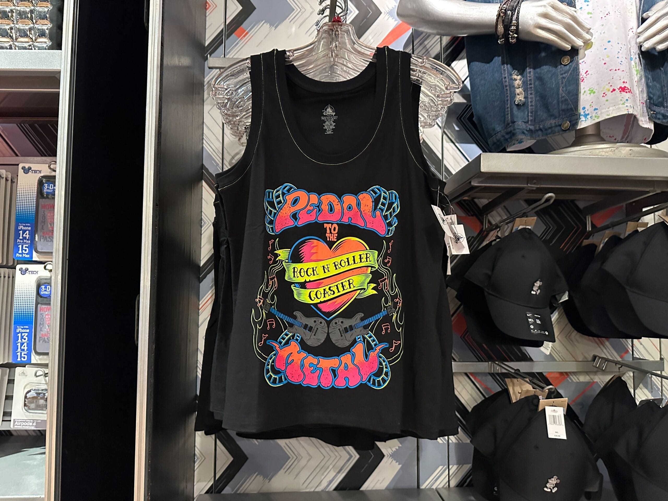 A black tank top with colorful text for Disney's Hollywood Studios Rock 'n' Roller Coaster merch hangs on a rack.