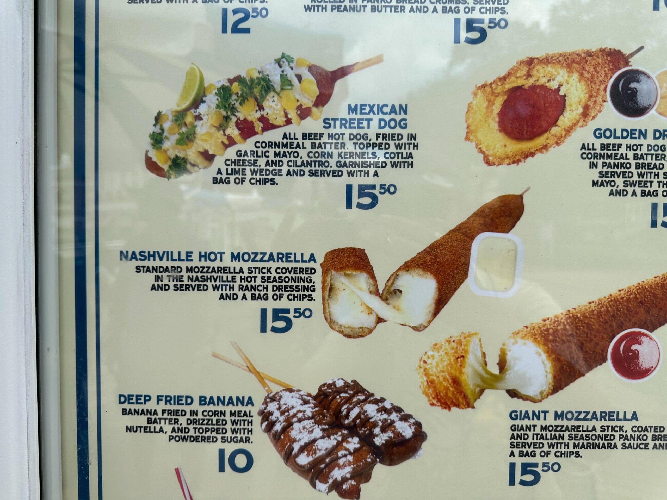 Menu with photos of Blue Ribbon Corn Dog, Nashville Hot mozzarella stick, and deep fried banana, each priced at $15.50.