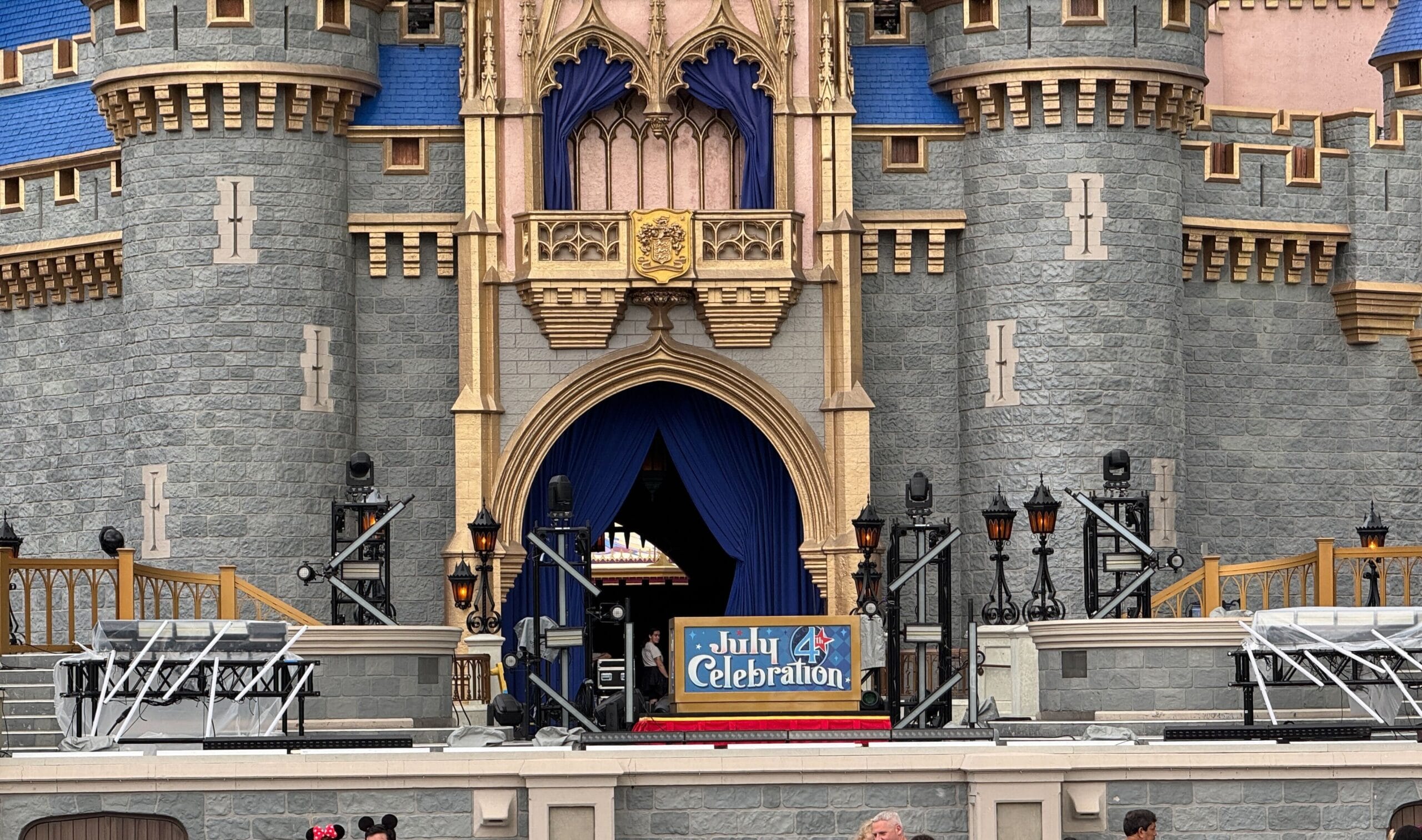 Stage in front of a castle with "July 4th Celebration" sign, set to celebrate America with lights, speakers, and fireworks.