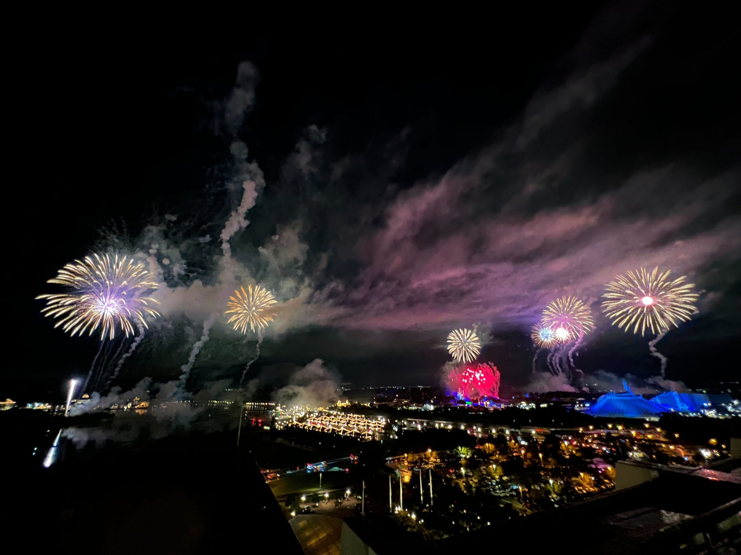 Fireworks light up the night sky as colorful buildings celebrate America on the Fourth of July 2025.