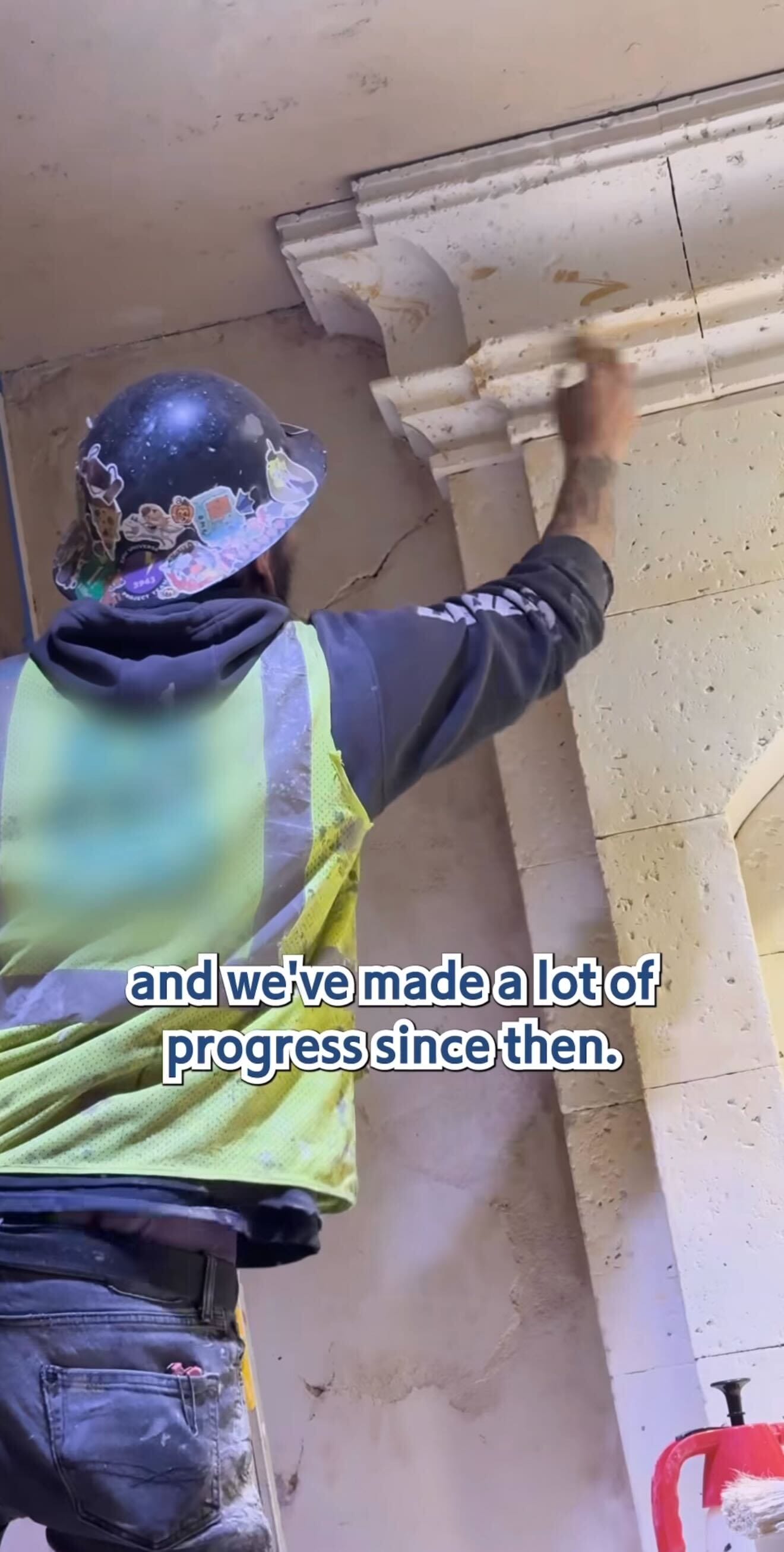 A construction worker in a vest and hard hat restores ornate stonework at the Pirates Tavern. “And we’ve made a lot of progress since then.”