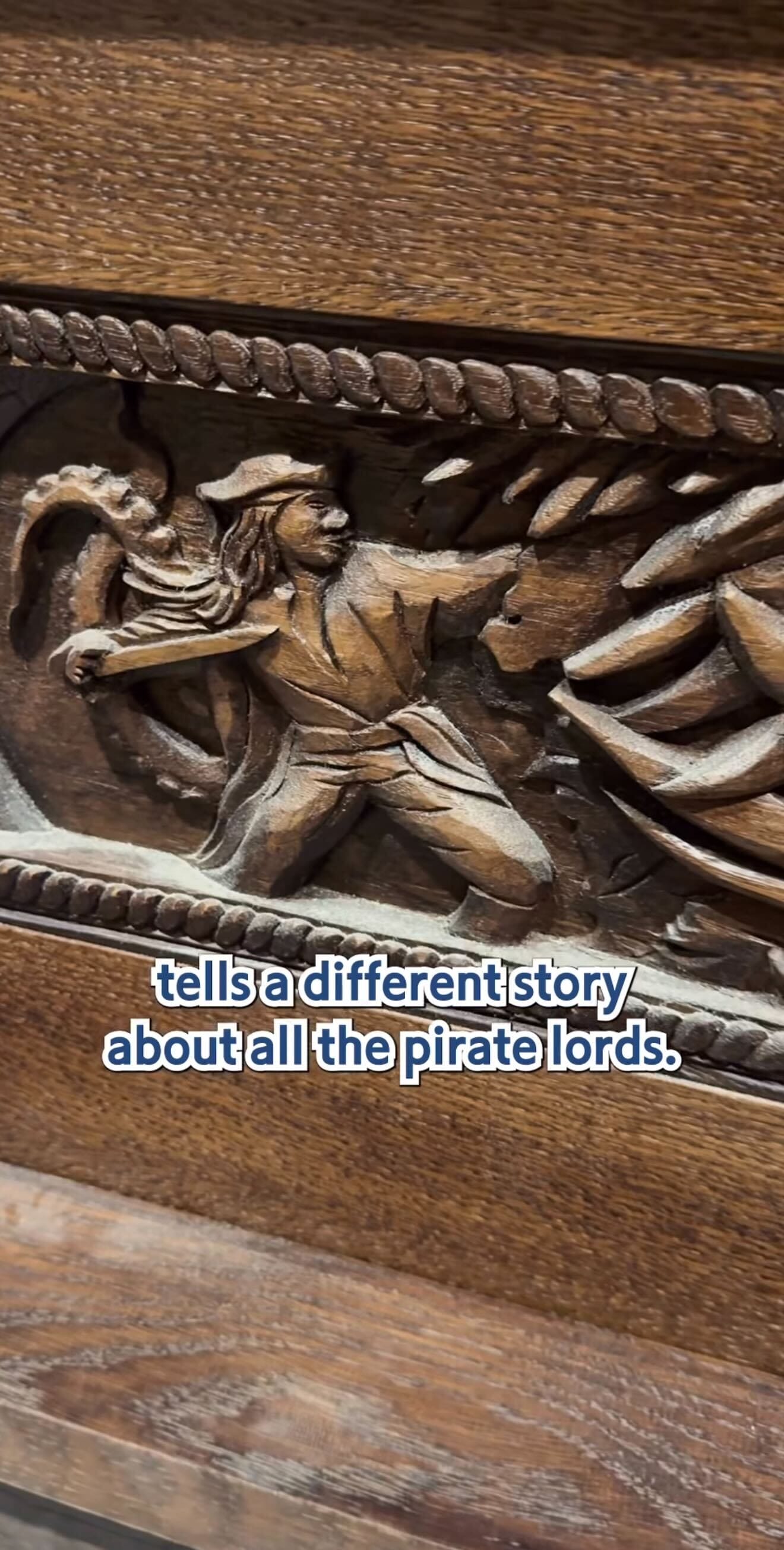 Carved wooden panel of a pirate at The Beak and Barrel—tells a different story about all the pirate lords.