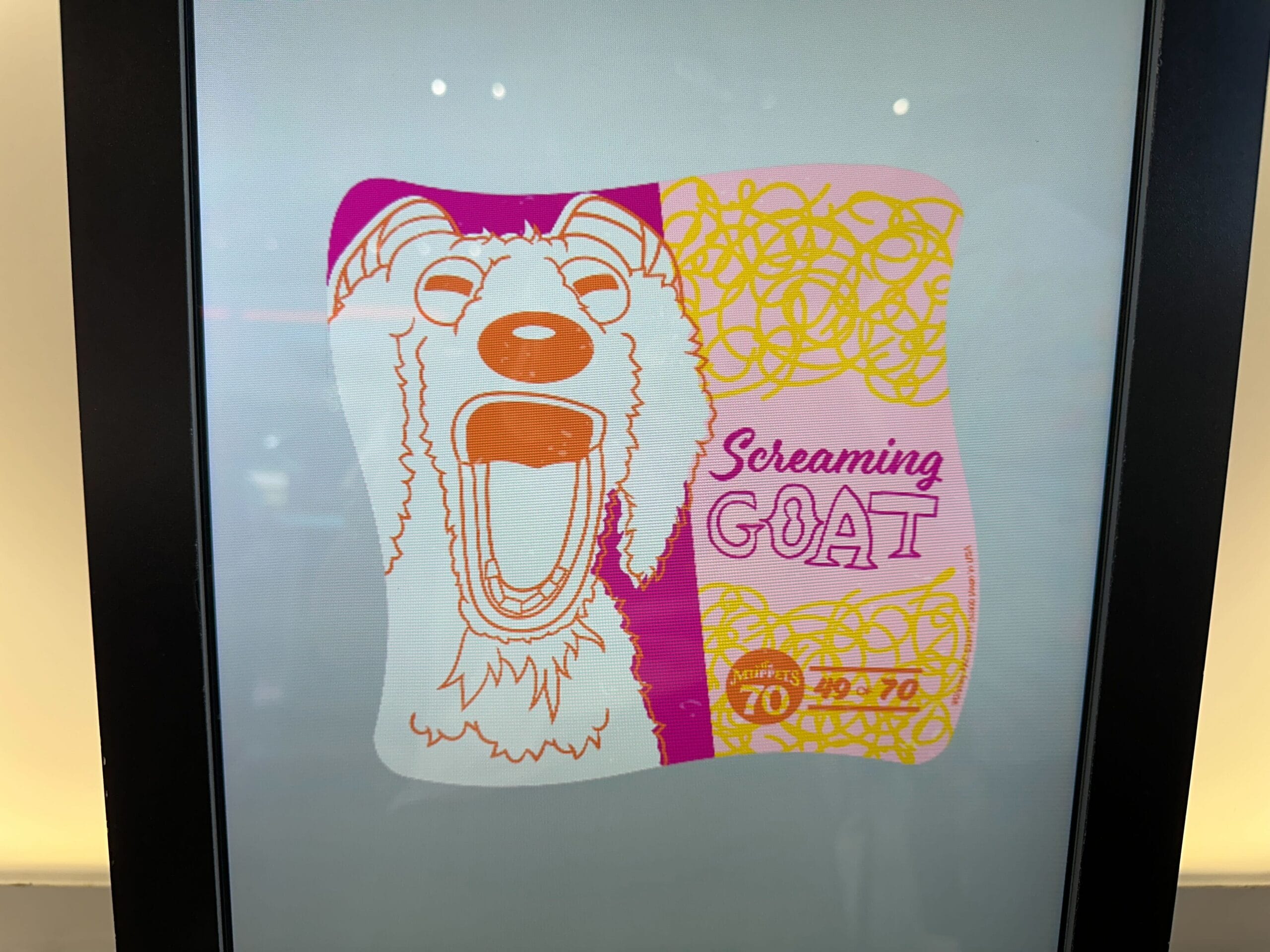 Illustration of a wide-mouthed goat with "Screaming GOAT" text on a vibrant Muppet 70th Anniversary background.