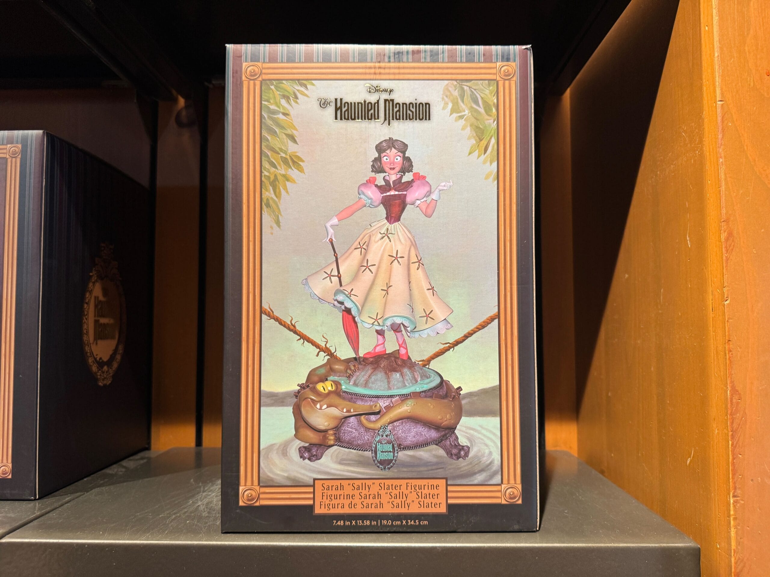 Box featuring Haunted Mansion merch: Sarah “Sally” Slater balances on a tightrope above a crocodile. Magic Kingdom collectible.