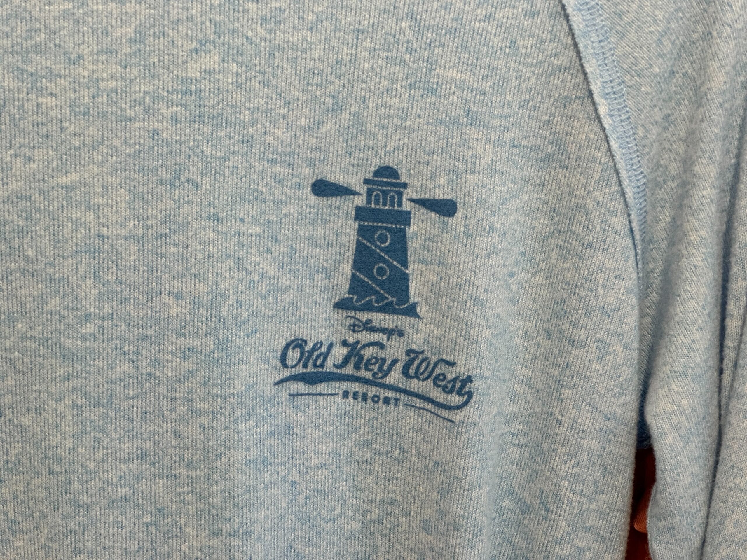 Blue Old Key West T-Shirt with a navy lighthouse graphic and "Old Key West Resort"—perfect Disney Vacation Club apparel.