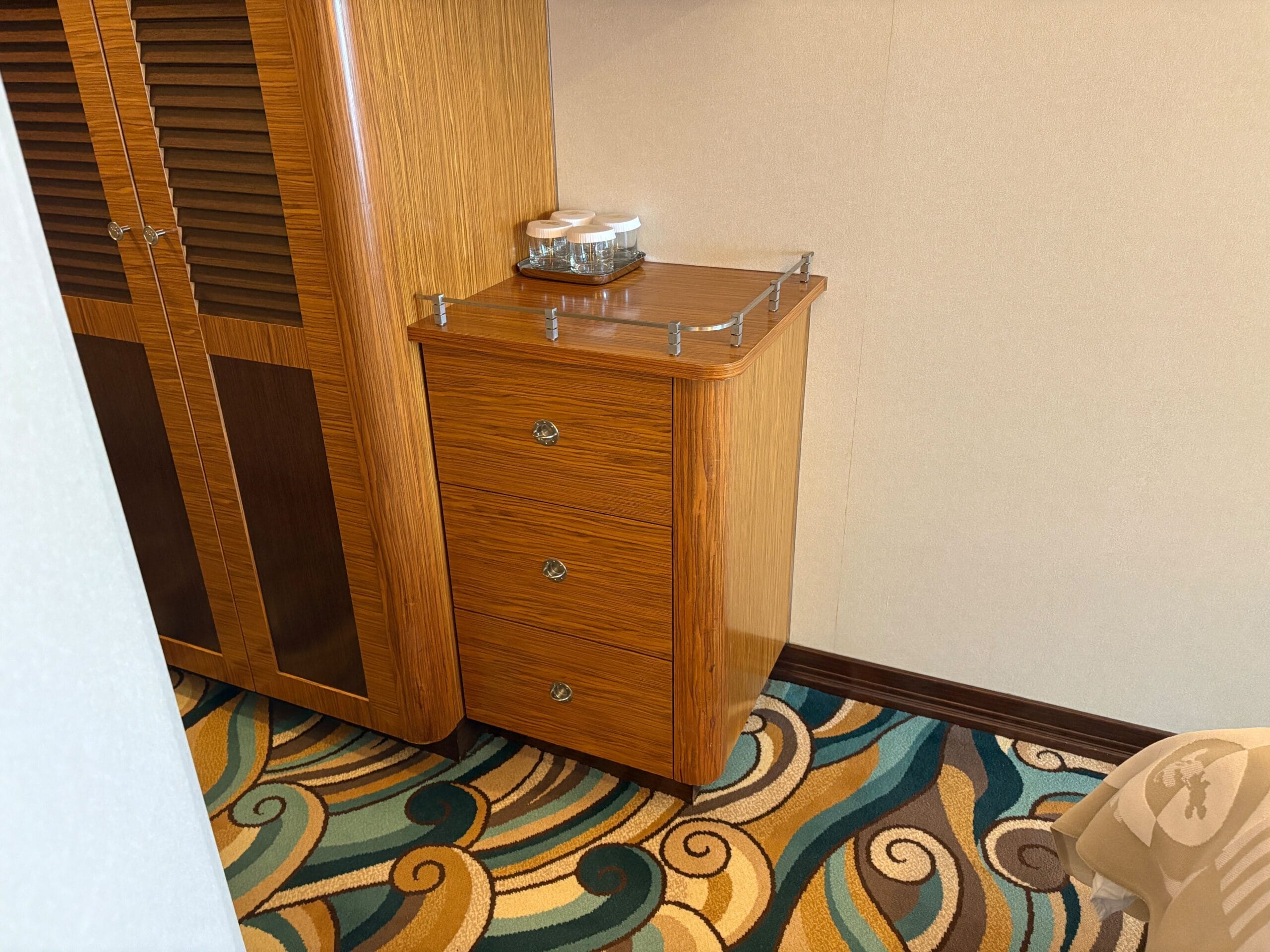 Wooden dresser with three drawers in a Concierge Family Oceanview Stateroom on the Disney Dream Cruise Ship.