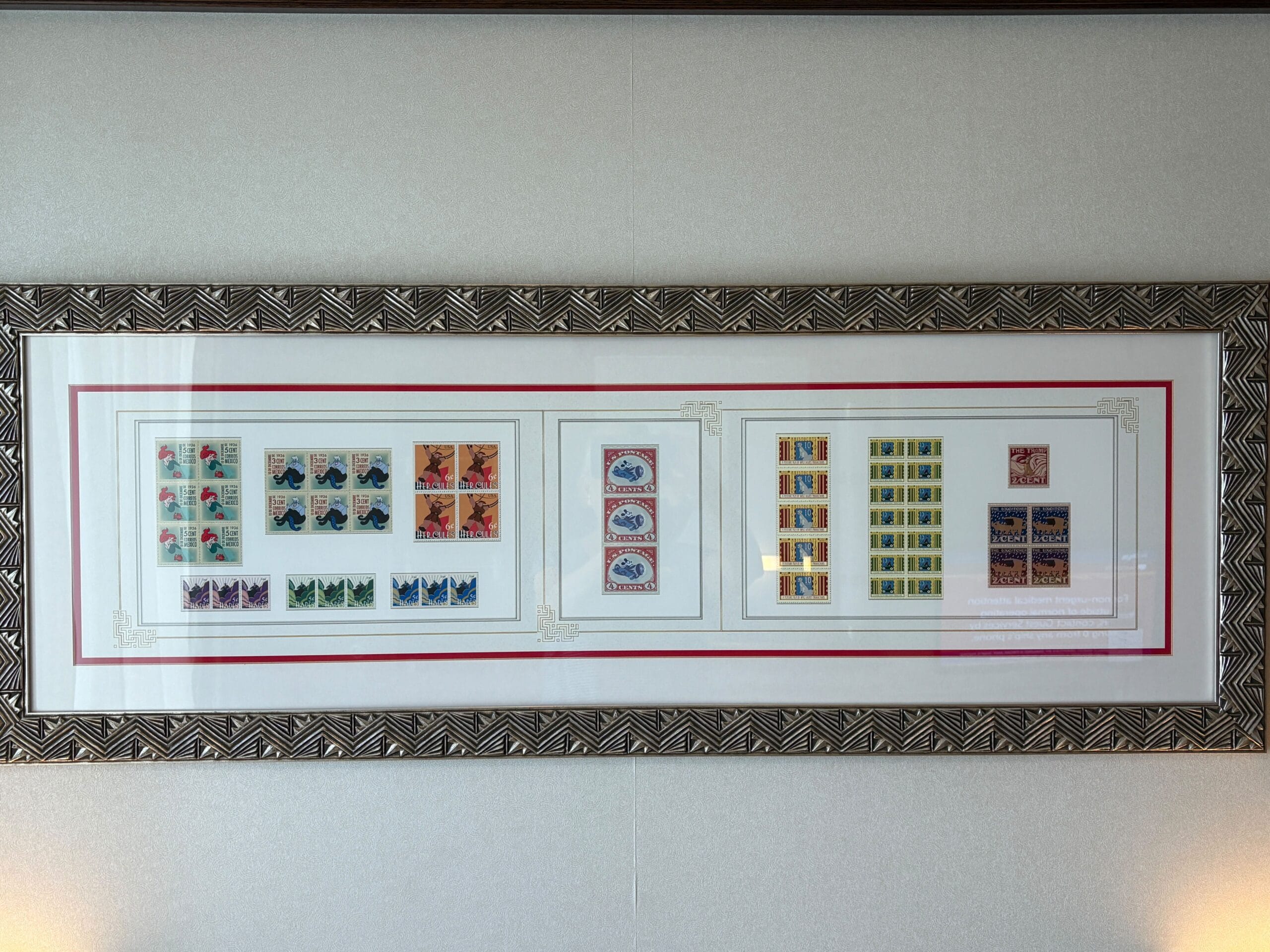 Framed display of colorful postage stamps in neat rows, reminiscent of a Disney Dream Cruise Ship’s decorative verandah.