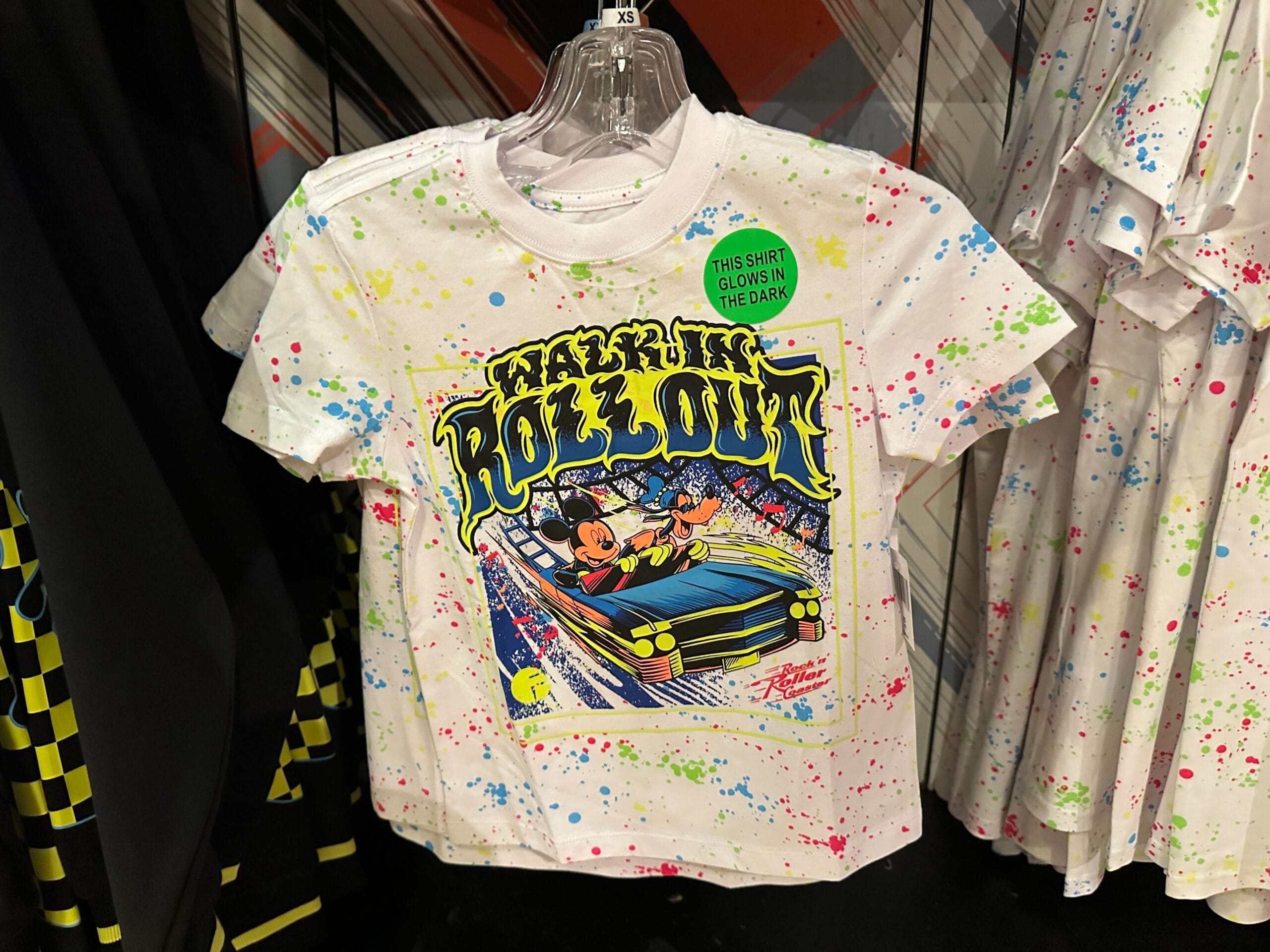 White T-shirt with colorful splatters, Mickey and friends in a car, inspired by Rock 'n' Roller Coaster at Disney's Hollywood Studios.