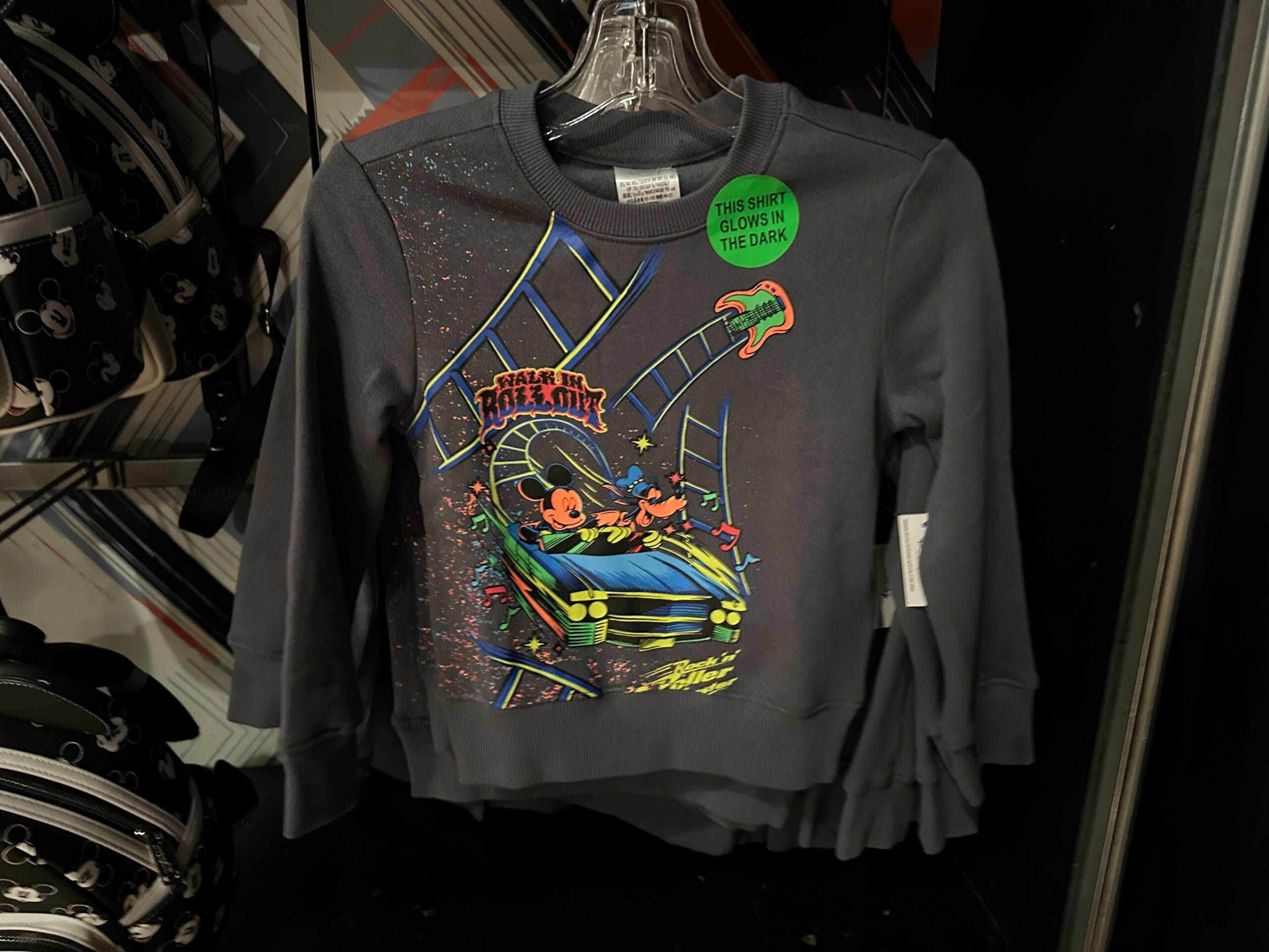Black kids’ sweatshirt featuring Disney's Hollywood Studios Rock 'n' Roller Coaster glow-in-the-dark design with Mickey & Minnie.