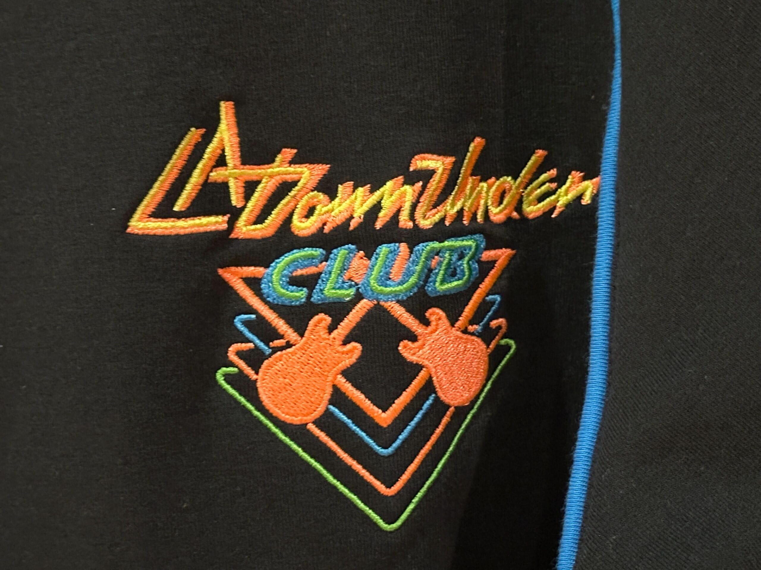 Embroidered “L.A. Townshoken Club” logo with neon guitars, inspired by Rock 'n' Roller Coaster apparel.