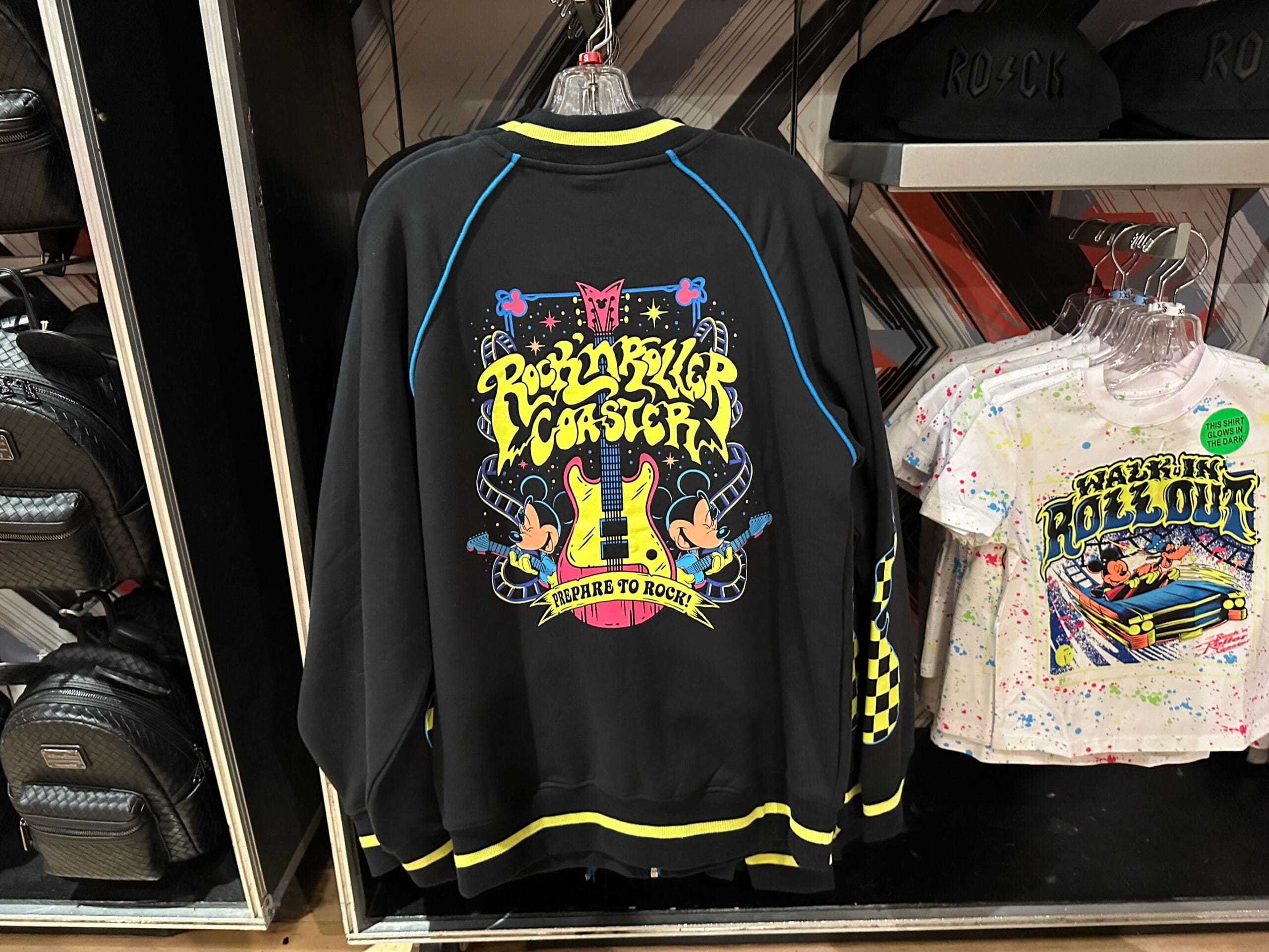 A Rock 'n' Roller Coaster jacket with colorful graphics hangs with apparel at Disney's Hollywood Studios.