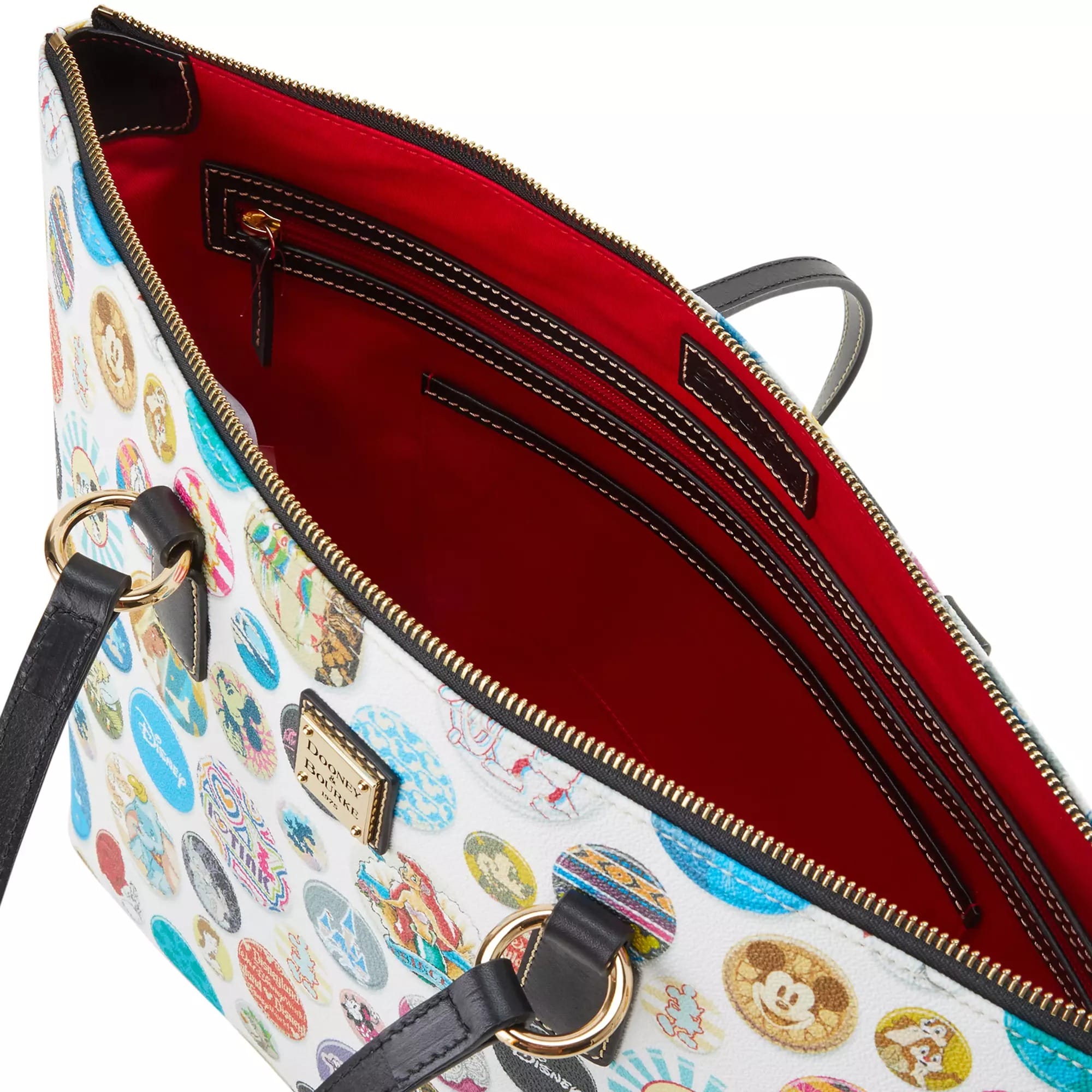 White tote bag with colorful Disney designs, black handles, red interior, gold accents—part of the Dooney & Bourke collection.