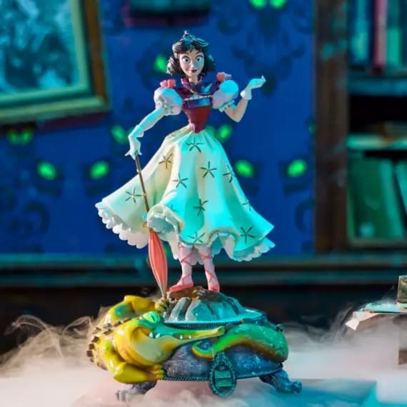 A Snow White figurine stands on a colorful base with a crocodile, surrounded by mist and books in the background.