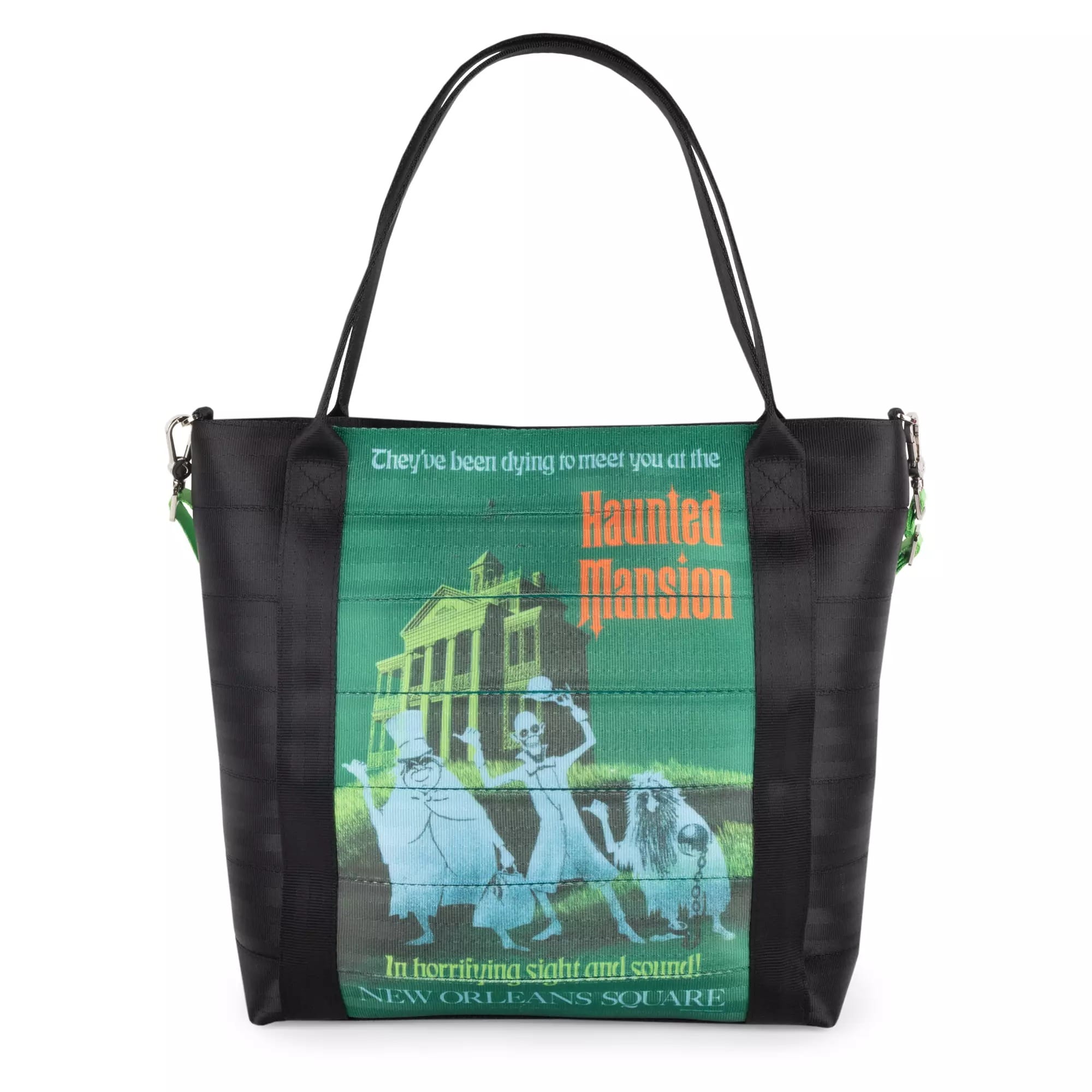 Black tote bag featuring Haunted Mansion artwork with three ghosts in front of a spooky house and stylized text.