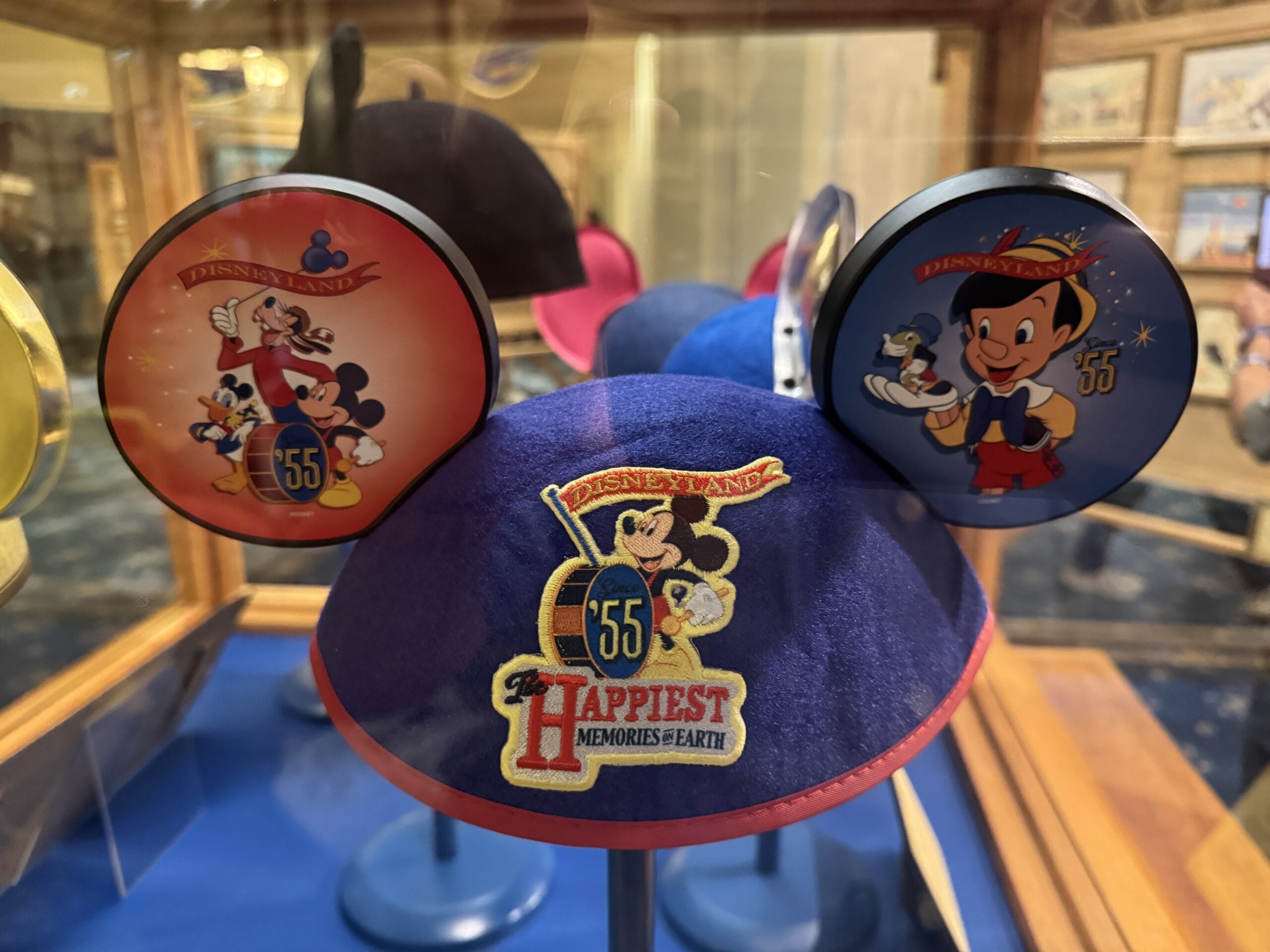 Blue Disneyland hat with Mickey, Pinocchio, and Main Street Opera House photos for the park’s 55th anniversary.