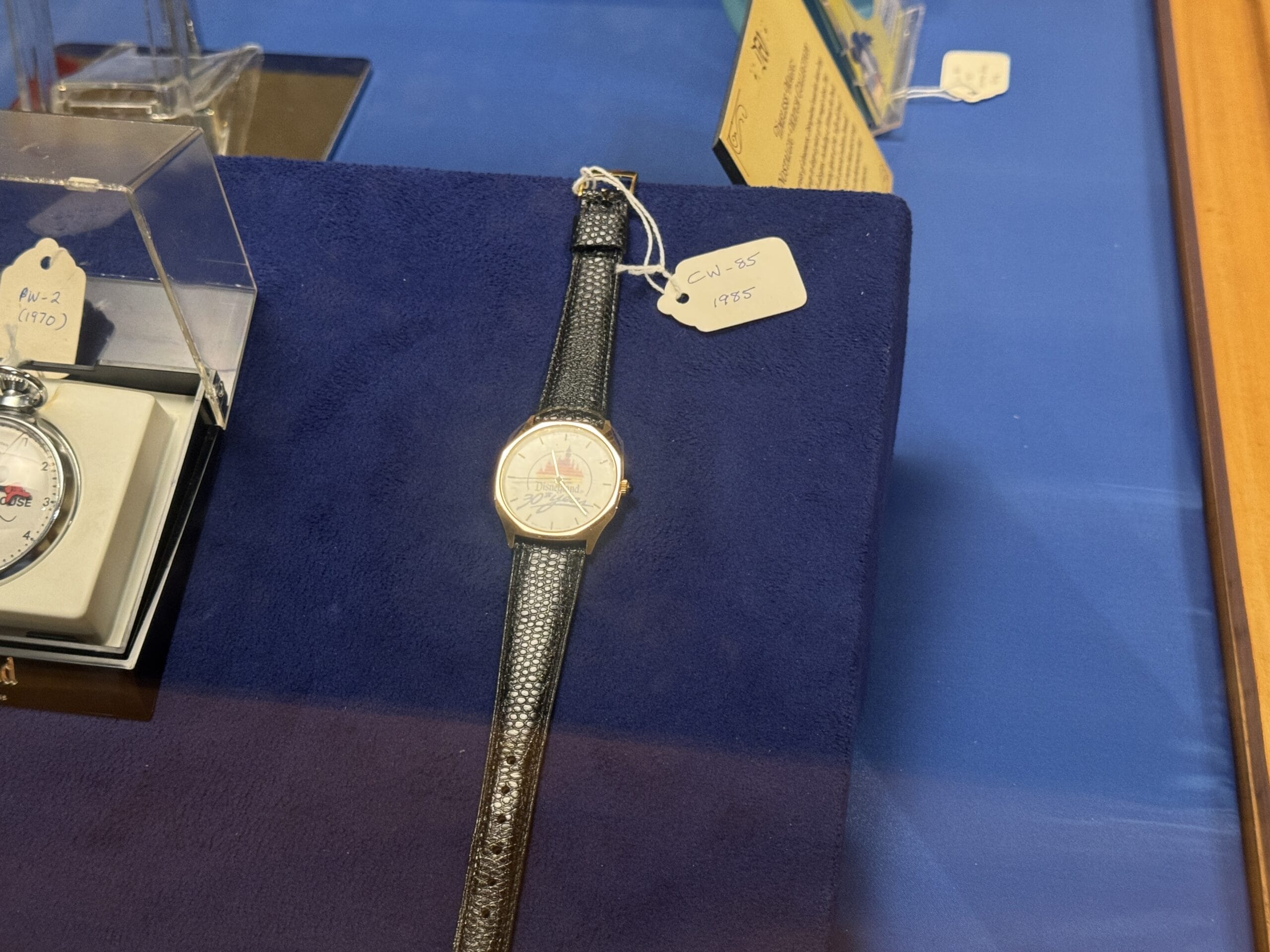 A wristwatch with a black strap and price tag displayed, reminiscent of new exhibits at the Main Street Opera House.