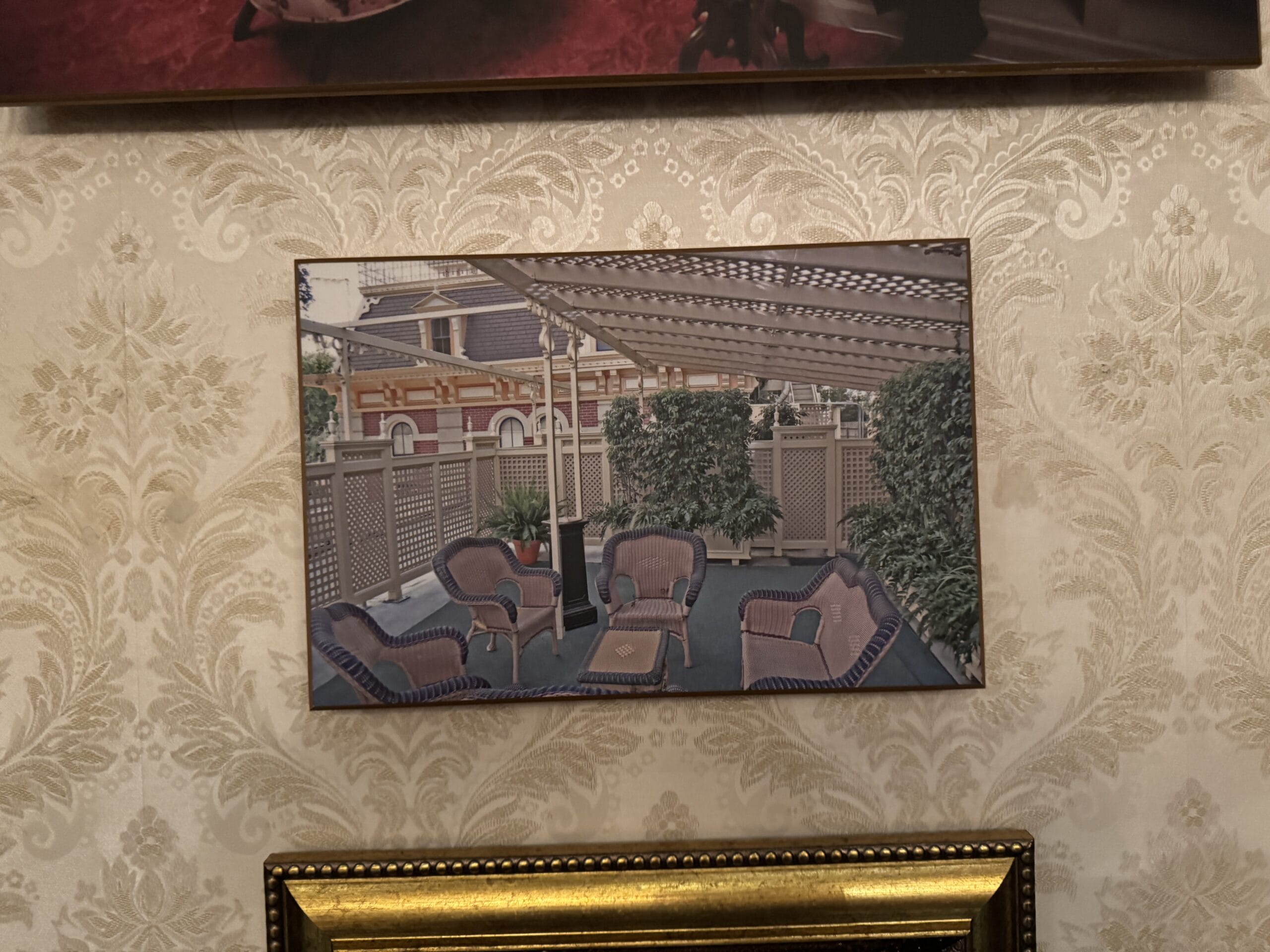 Framed photo of an outdoor patio with wicker chairs, part of the new exhibits at Main Street Opera House.