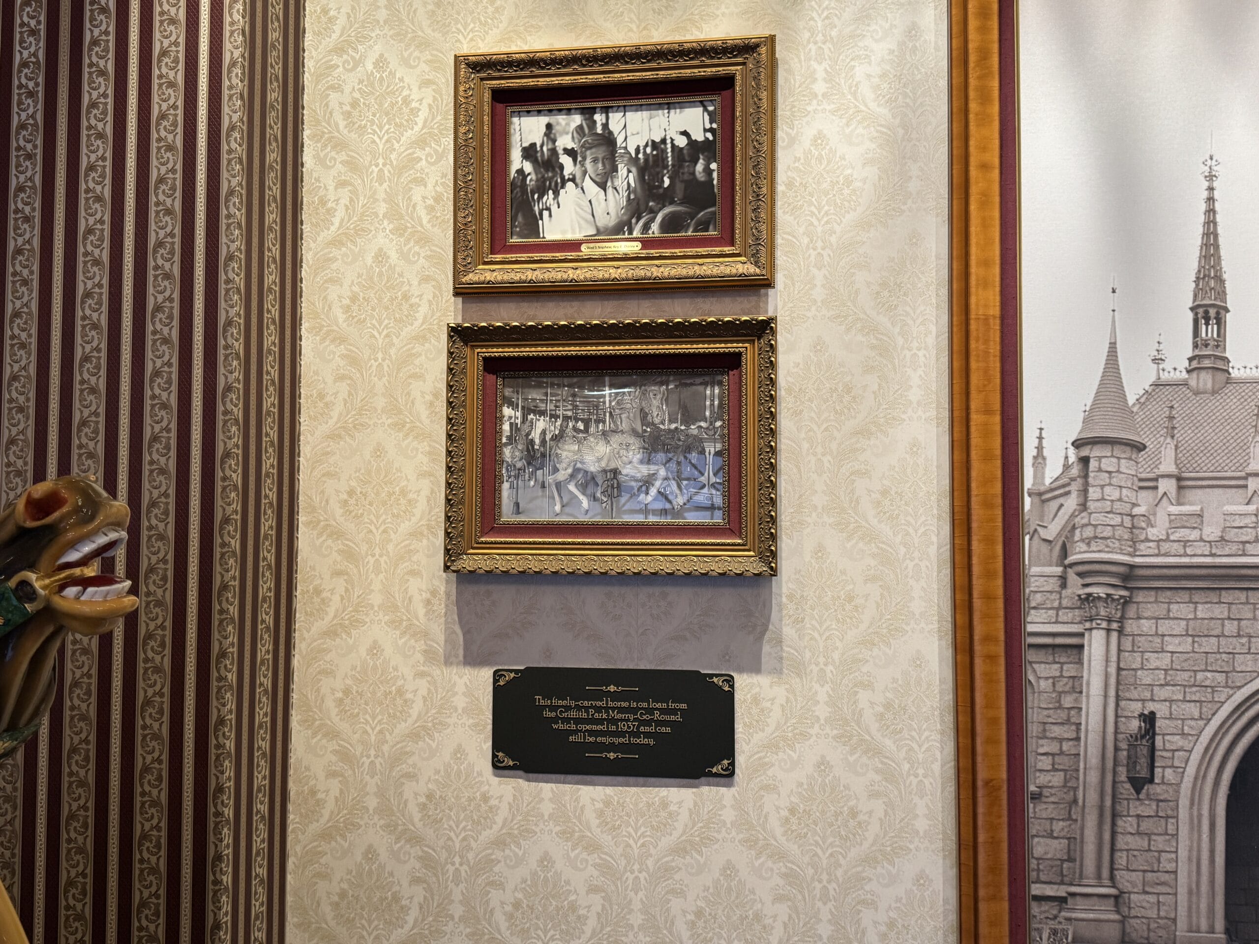 Two framed vintage photos hang above a plaque, highlighting Main Street Opera House and Disneyland history.