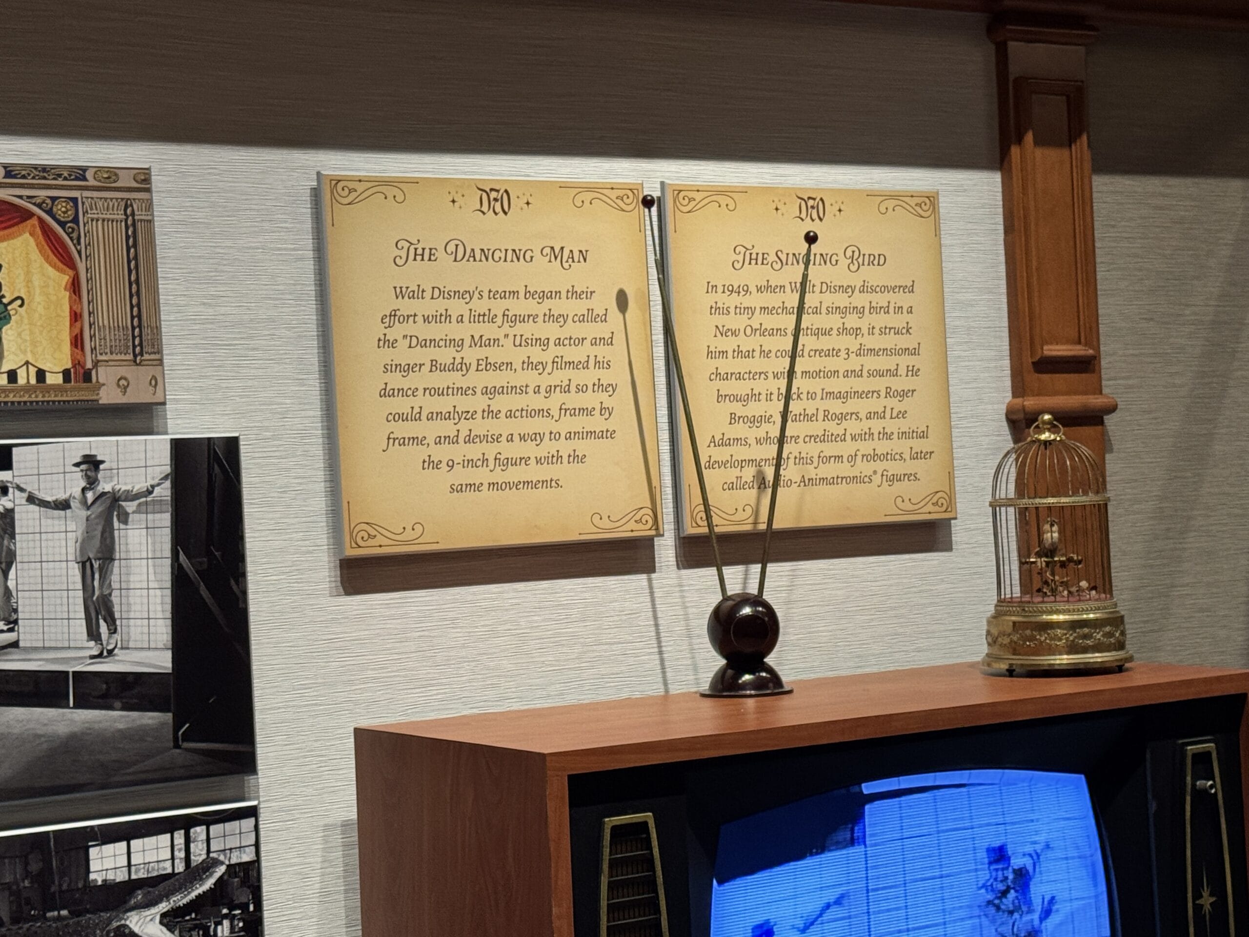 Two plaques titled "The Dancing Man" and "The Singing Bird" evoke the charm of a main street opera house display.