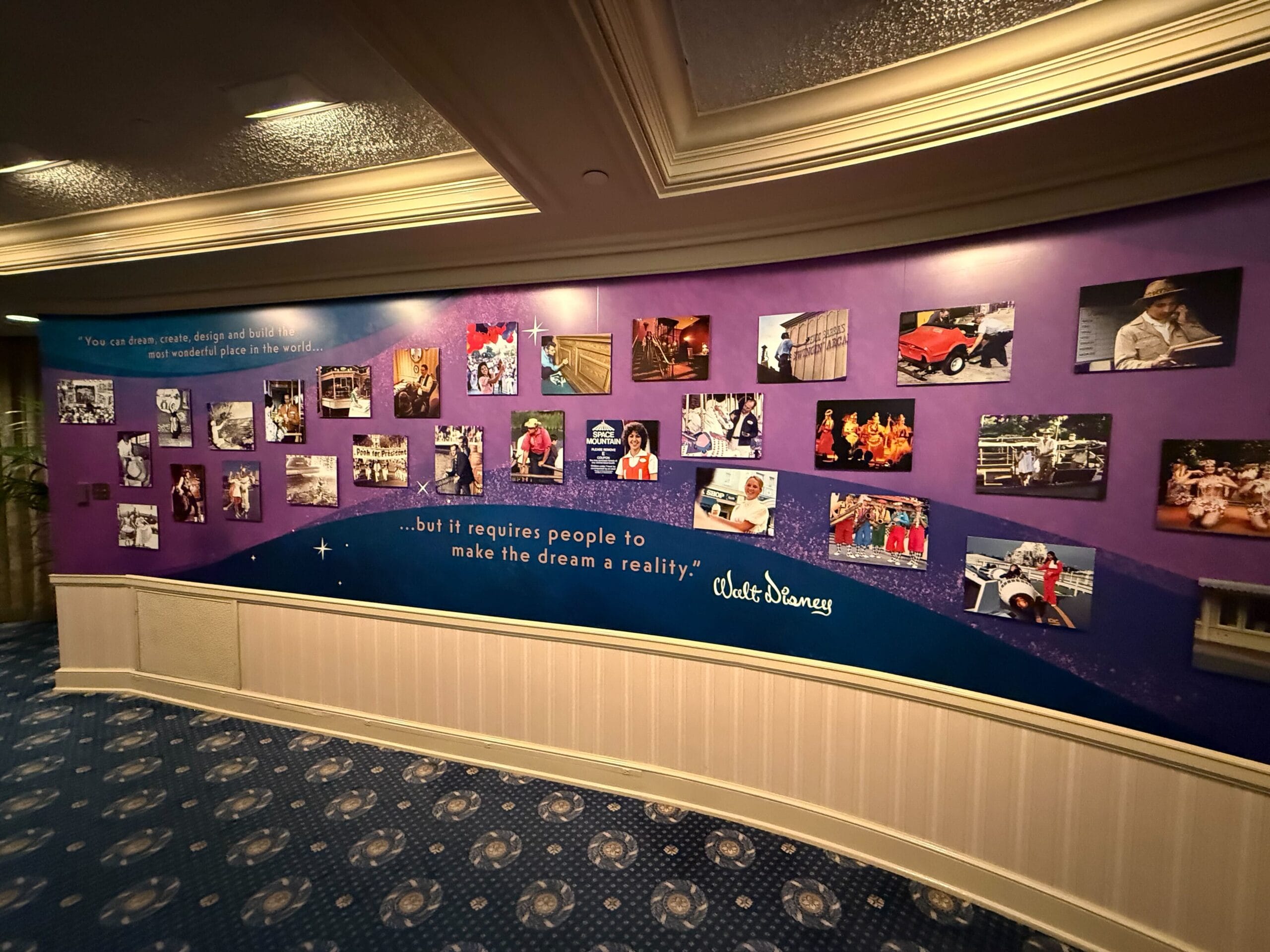 Purple wall display at the Main Street Opera House with Walt Disney photos, memorabilia, and a quote honoring Disney dream makers.