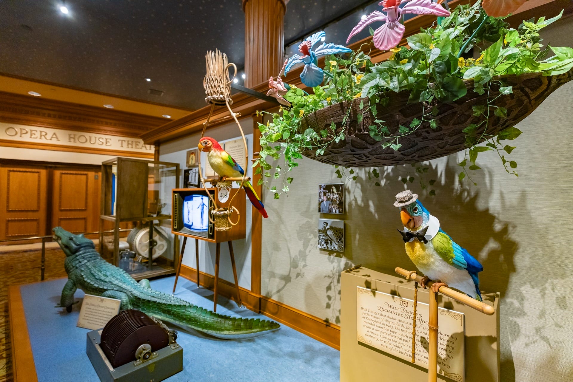 Animatronic birds and plants evoke Disneyland history in a vintage-themed exhibit near the Main Street Opera House entrance.