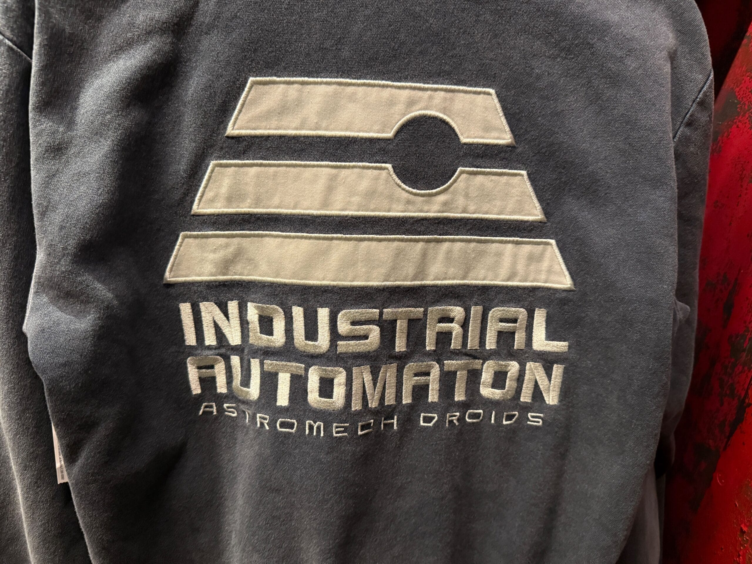 Gray shirt with "Industrial Automaton Astromech Droids" and a geometric logo printed in white on the back.