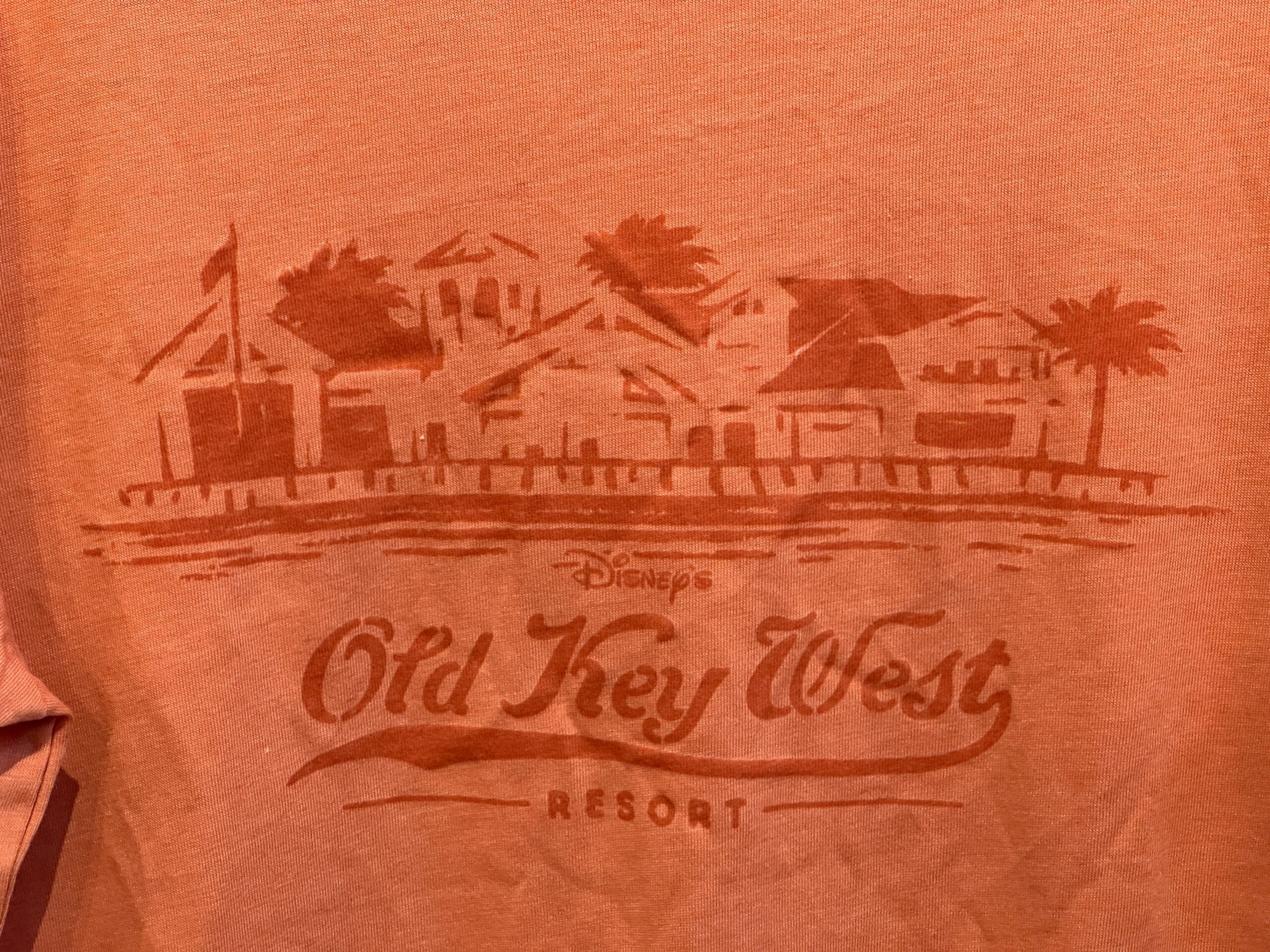 Rust-colored Old Key West T-Shirt features building sketches, palm trees, and Disney Vacation Club resort text.