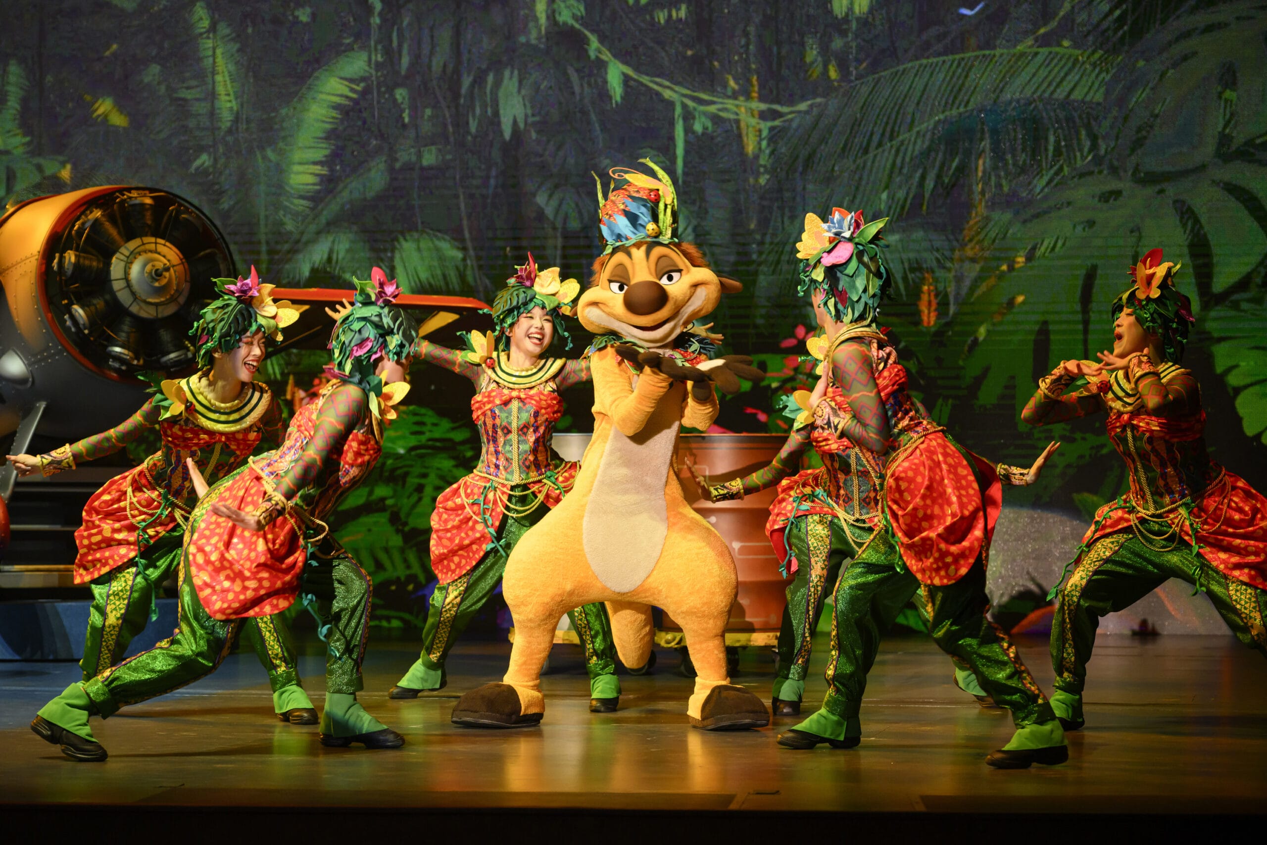A performer in a meerkat costume dances on stage at Tokyo DisneySea as dreams take flight with jungle-themed friends.