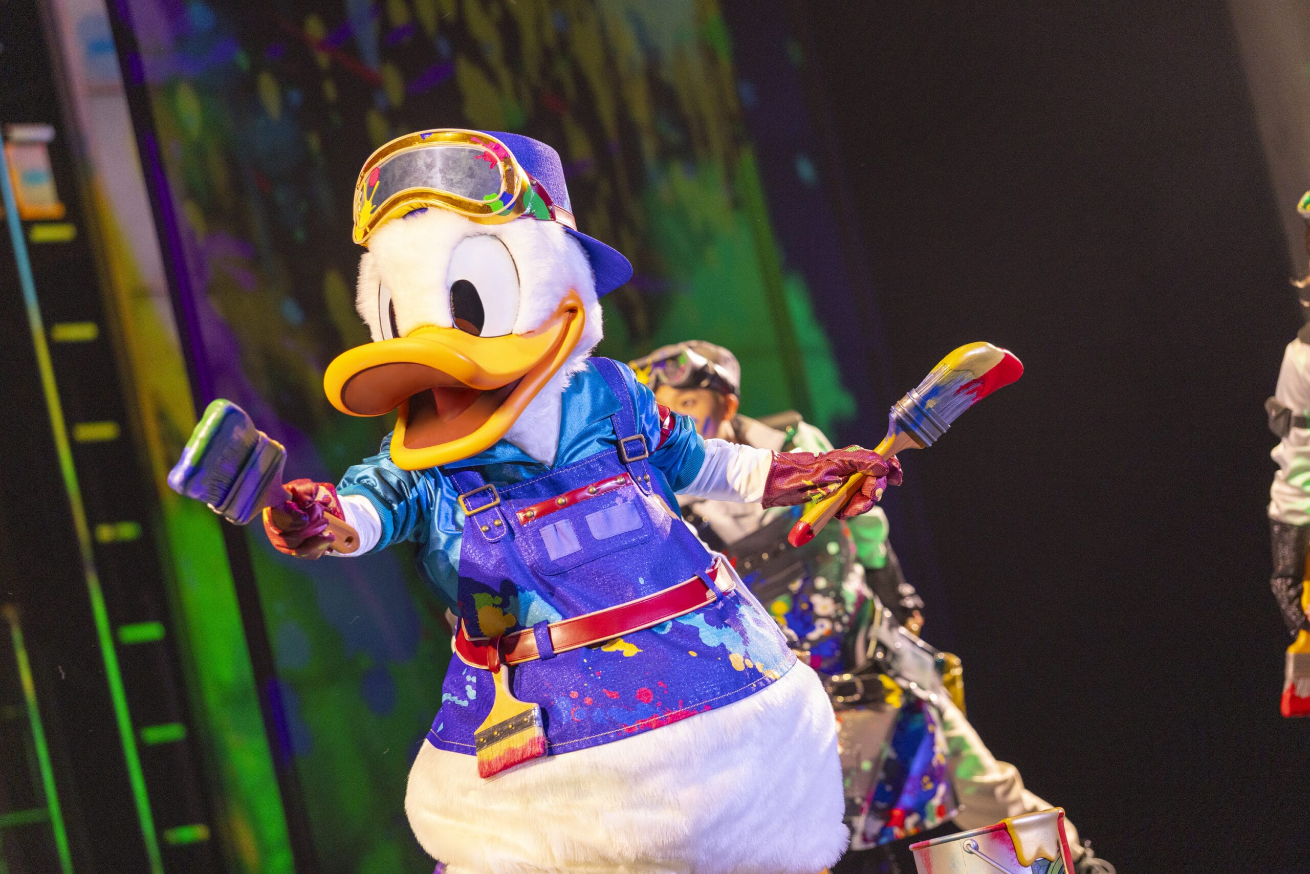 Donald Duck in a colorful painter outfit takes the stage at Tokyo DisneySea, where dreams take flight in vivid hues.