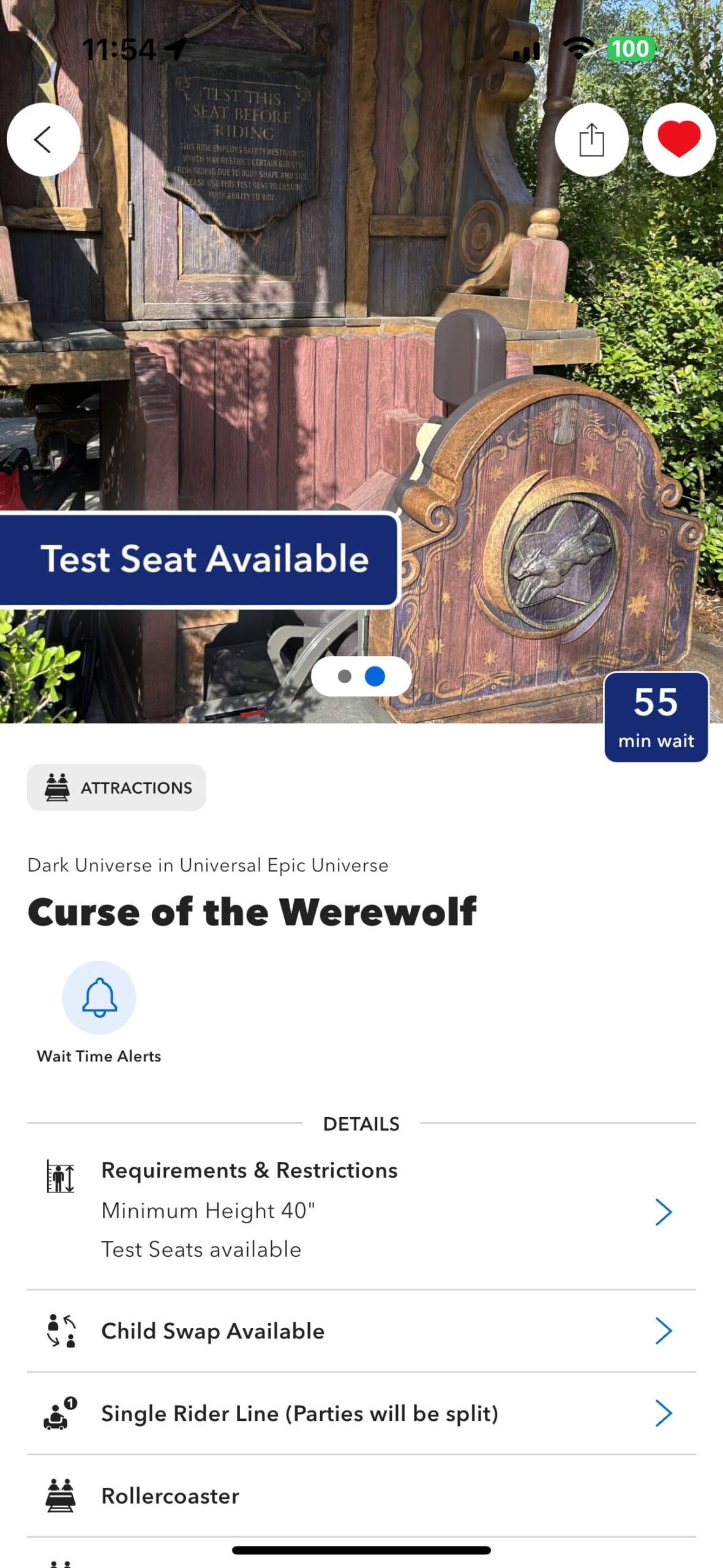 A test seat for the “Curse of the Werewolf” ride is displayed outside with a 55-minute wait sign in view.