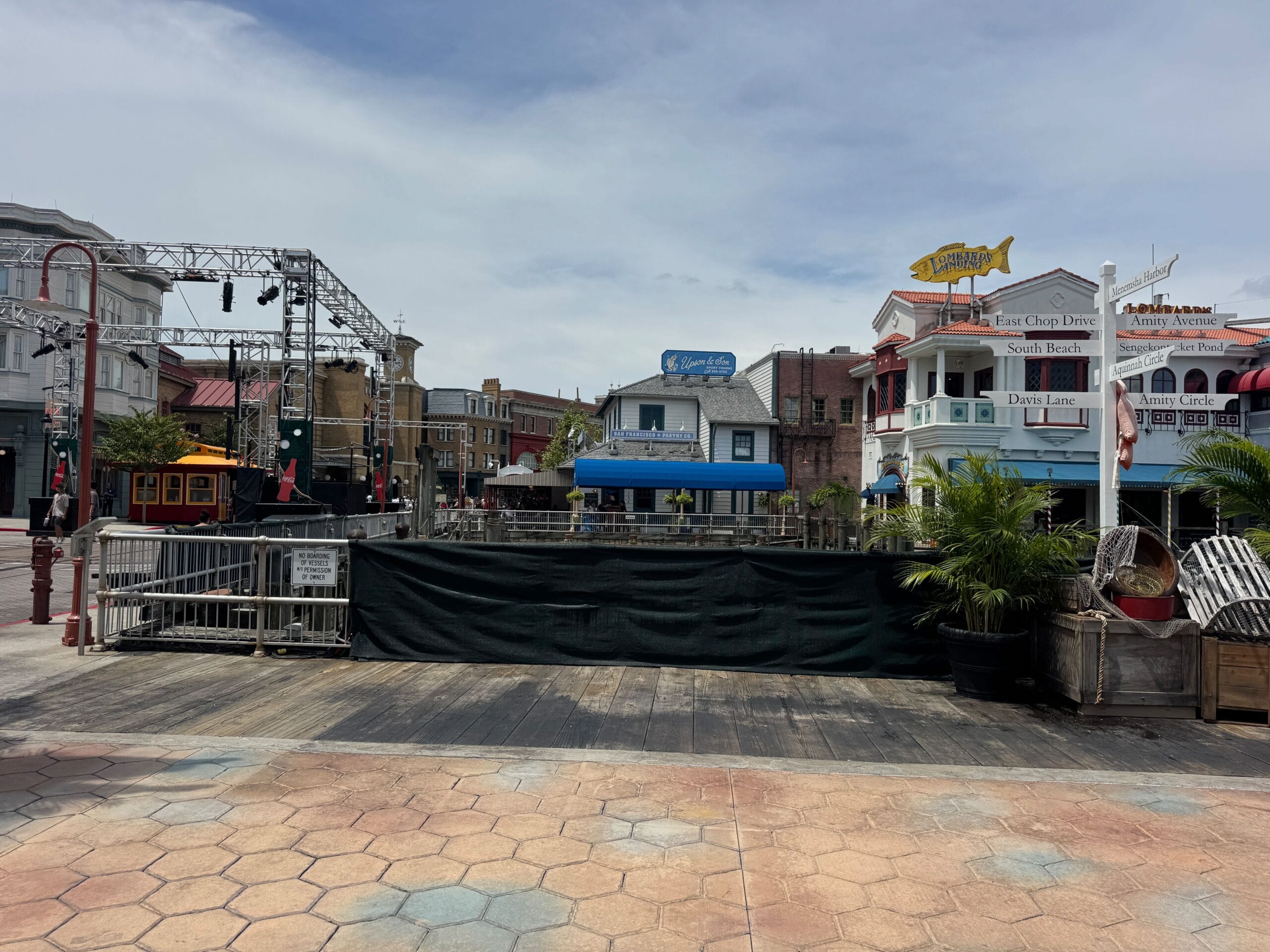 A blocked-off outdoor area in a themed shopping and dining district styled for Halloween Horror Nights.