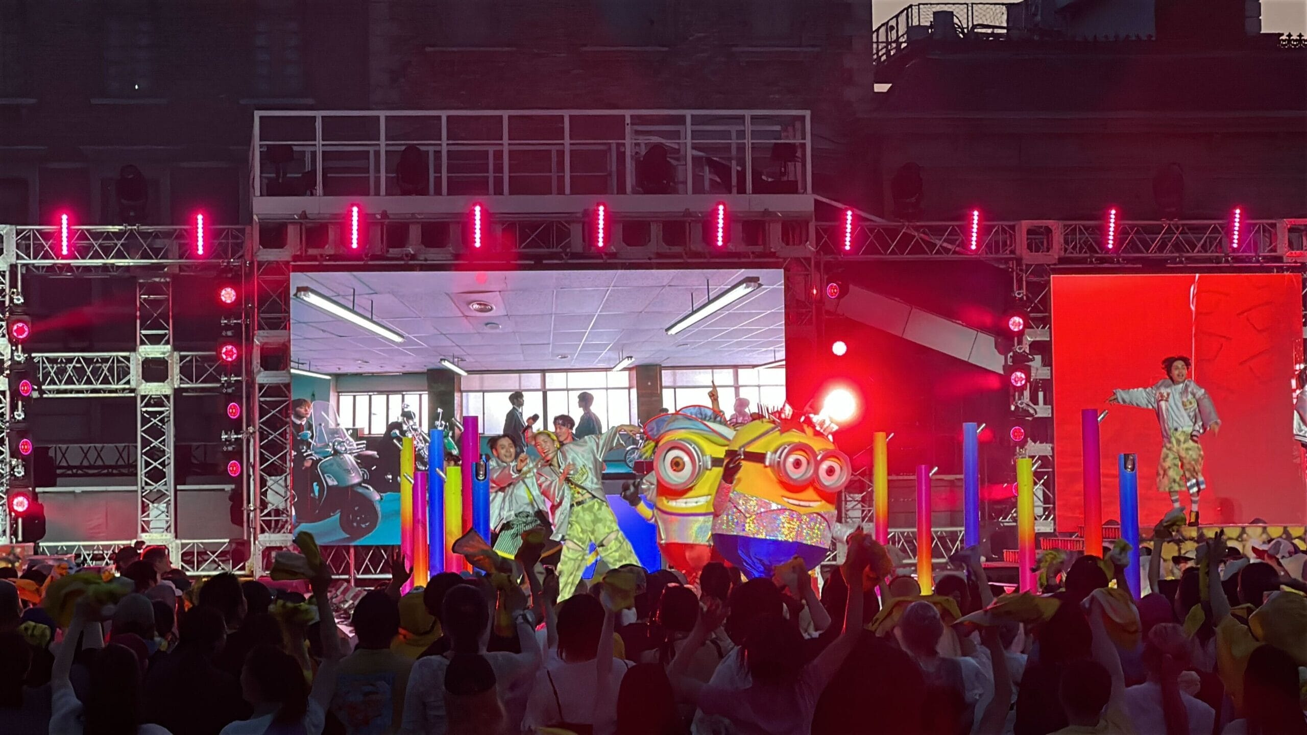 Performers in colorful costumes and lion heads dance on stage at Summer Dance Nights, captured in photos and video.