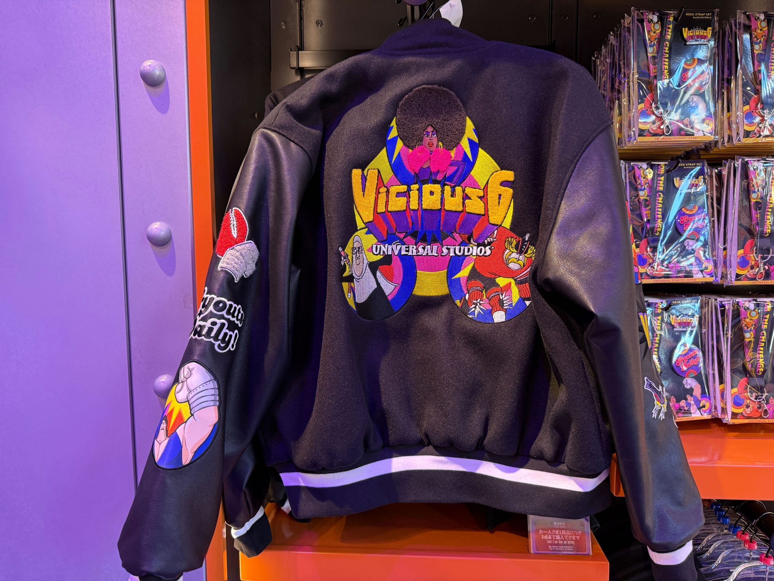 A black “Vicious 6 Universal Studios” jacket featuring colorful cartoon villains and logo graphics on the back and sleeves.
