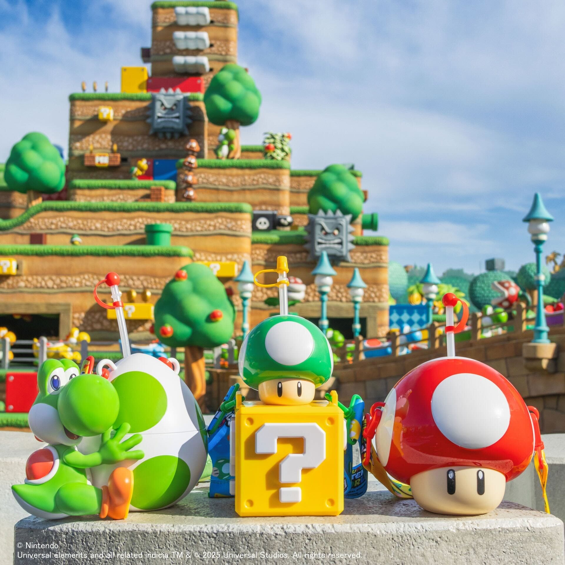 Colorful Super Nintendo World snacks shaped like Yoshi and mushrooms at Universal Studios Japan’s Mario-themed backdrop.