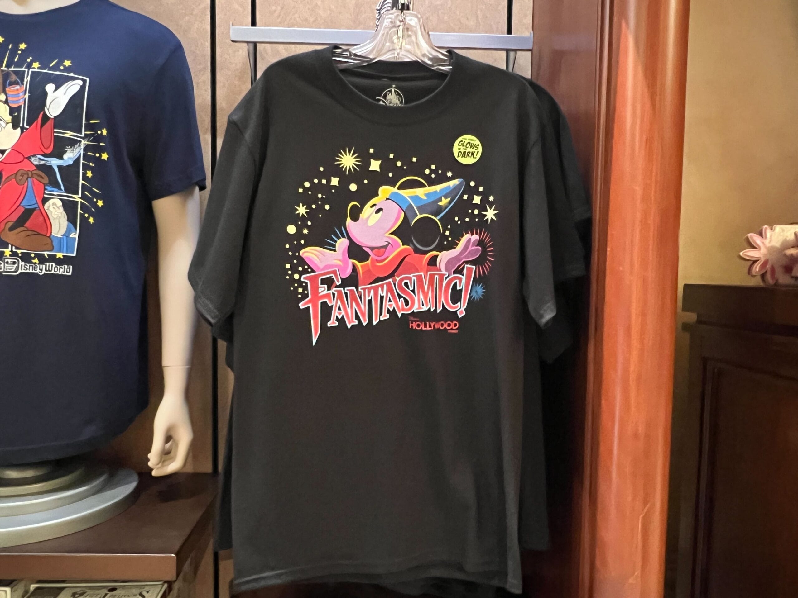 Black t-shirt featuring Sorcerer Mickey and “Fantasmic!” from Disney's Hollywood Studios in a colorful, cartoon style.