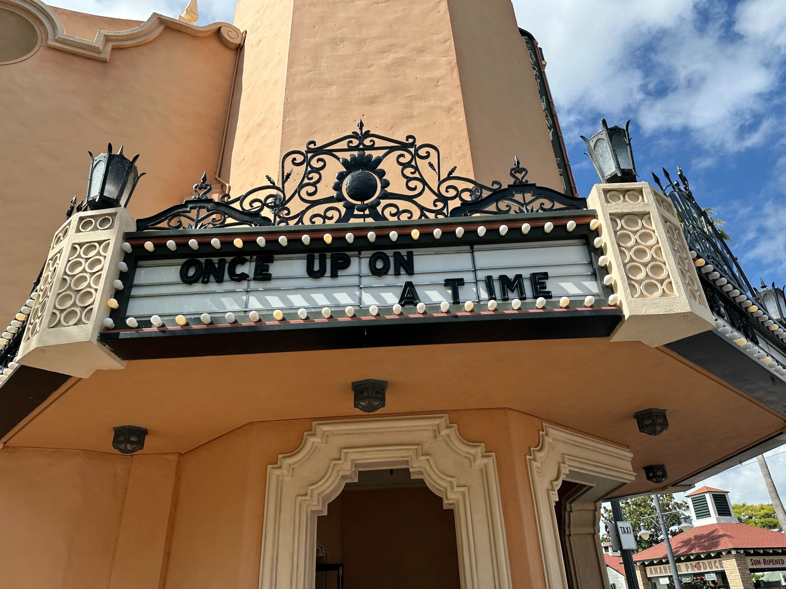 Theater marquee displays "ONCE UPON A TIME" Fantasmic style under a decorative arch at Disney's Hollywood Studios.