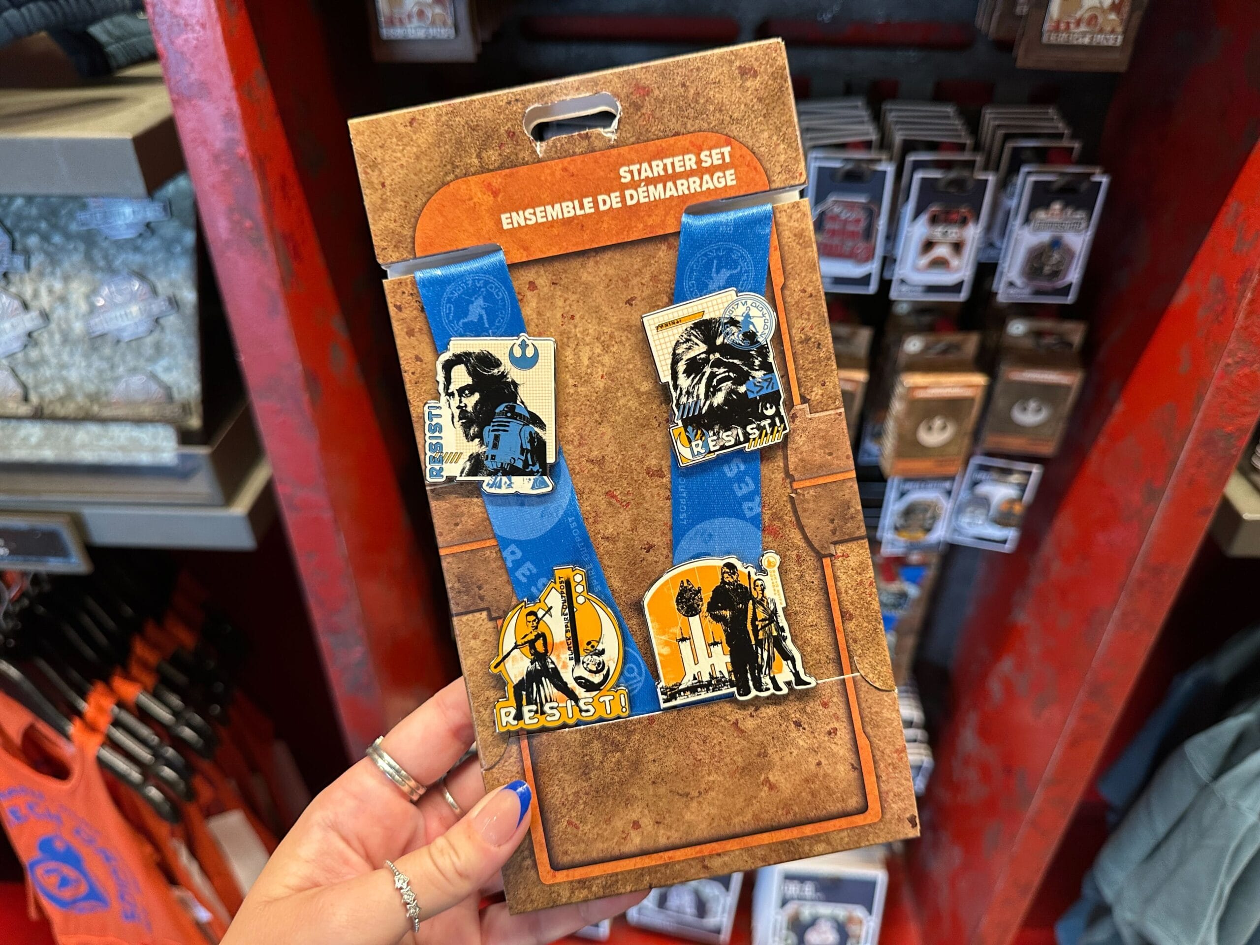 Starter set pack of Star Wars-themed pins on a blue lanyard, featuring "Resist," Boba Fett, and character designs.