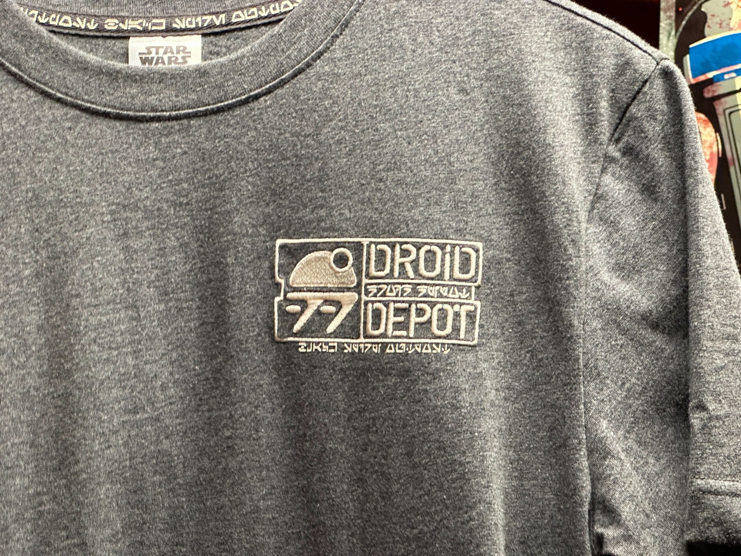 Gray T-shirt featuring an embroidered "Droid Depot" logo with a droid graphic and Star Wars branding.