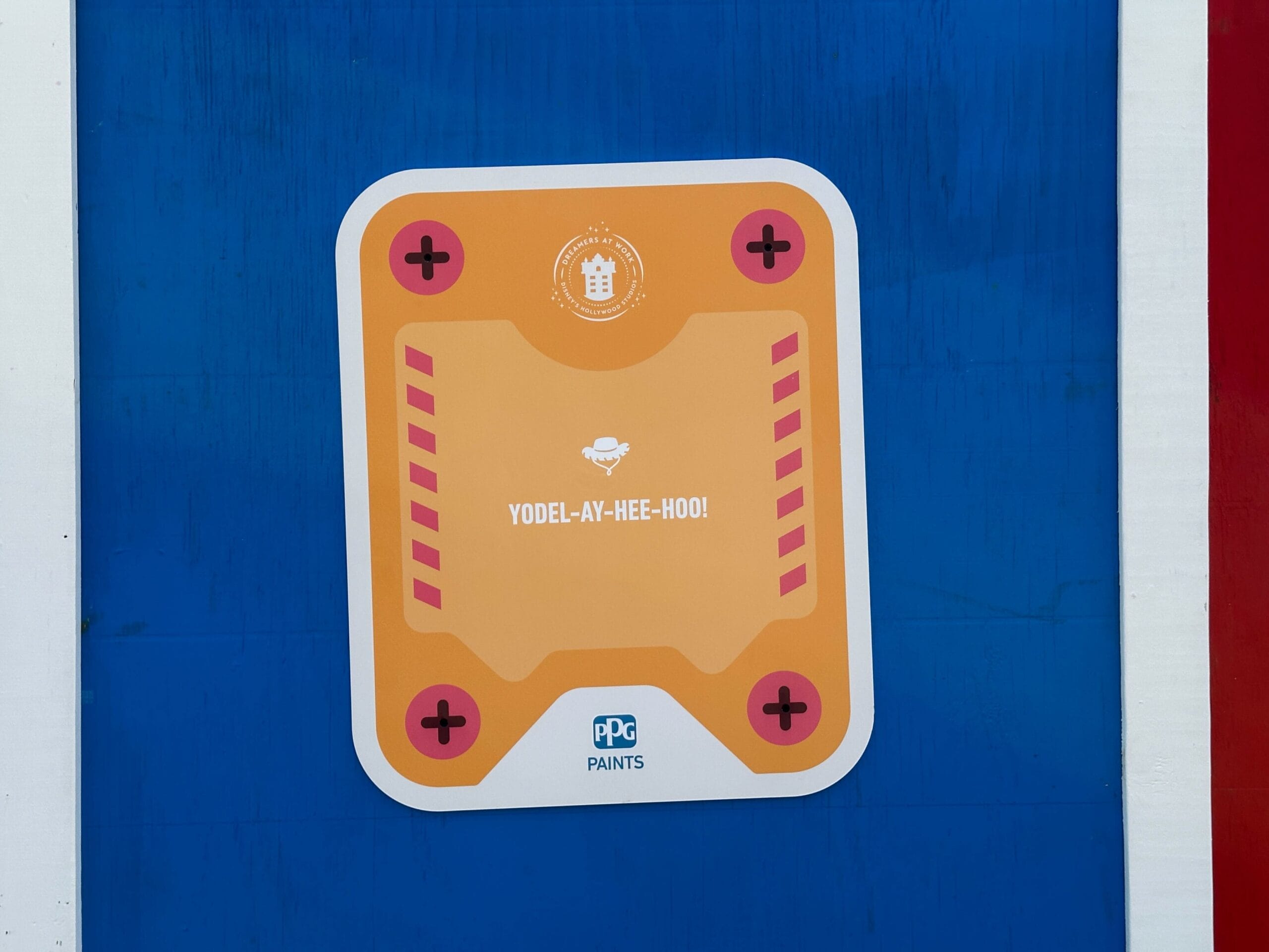 Orange sign with "YODEL-AY-HEE-HOO!" on blue, perfect for Toy Story Walls, PPG Paints logo at the bottom.