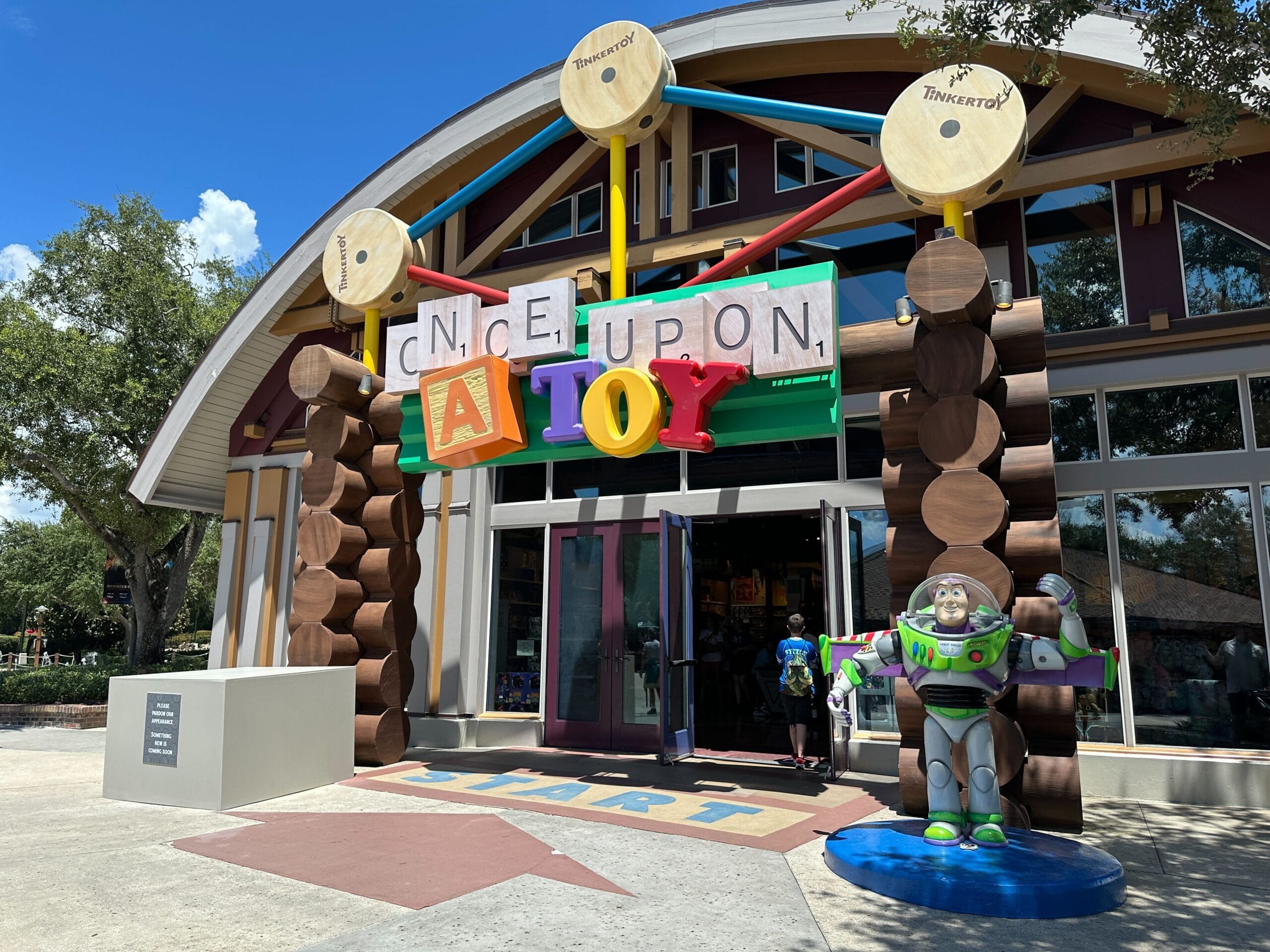 Storefront of "Once Upon a Toy" at Disney Springs with large toy blocks and a Buzz Lightyear statue at the entrance.