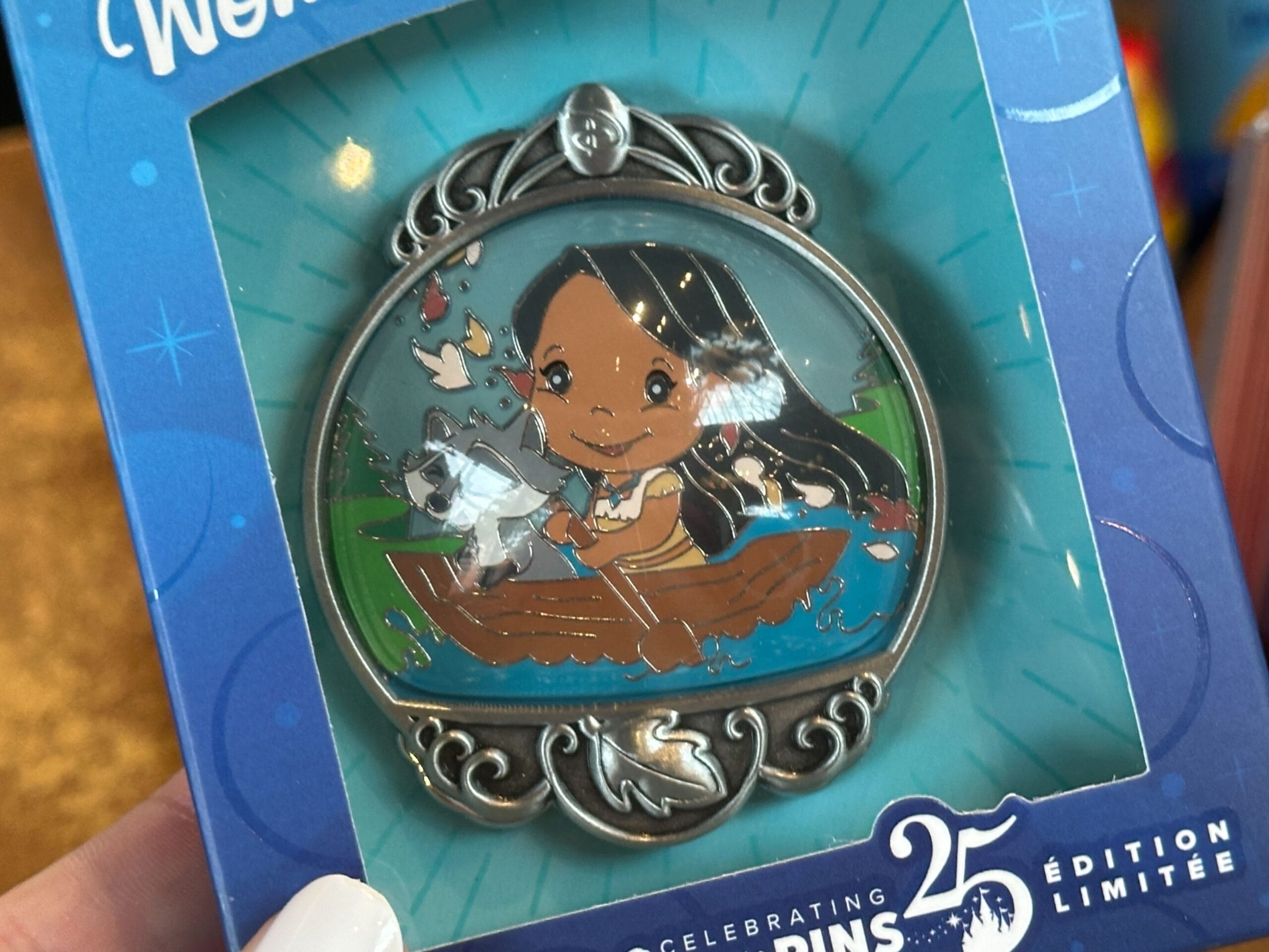 A decorative pin shows a cartoon girl with long hair in a boat, holding a paddle with animals beside her.