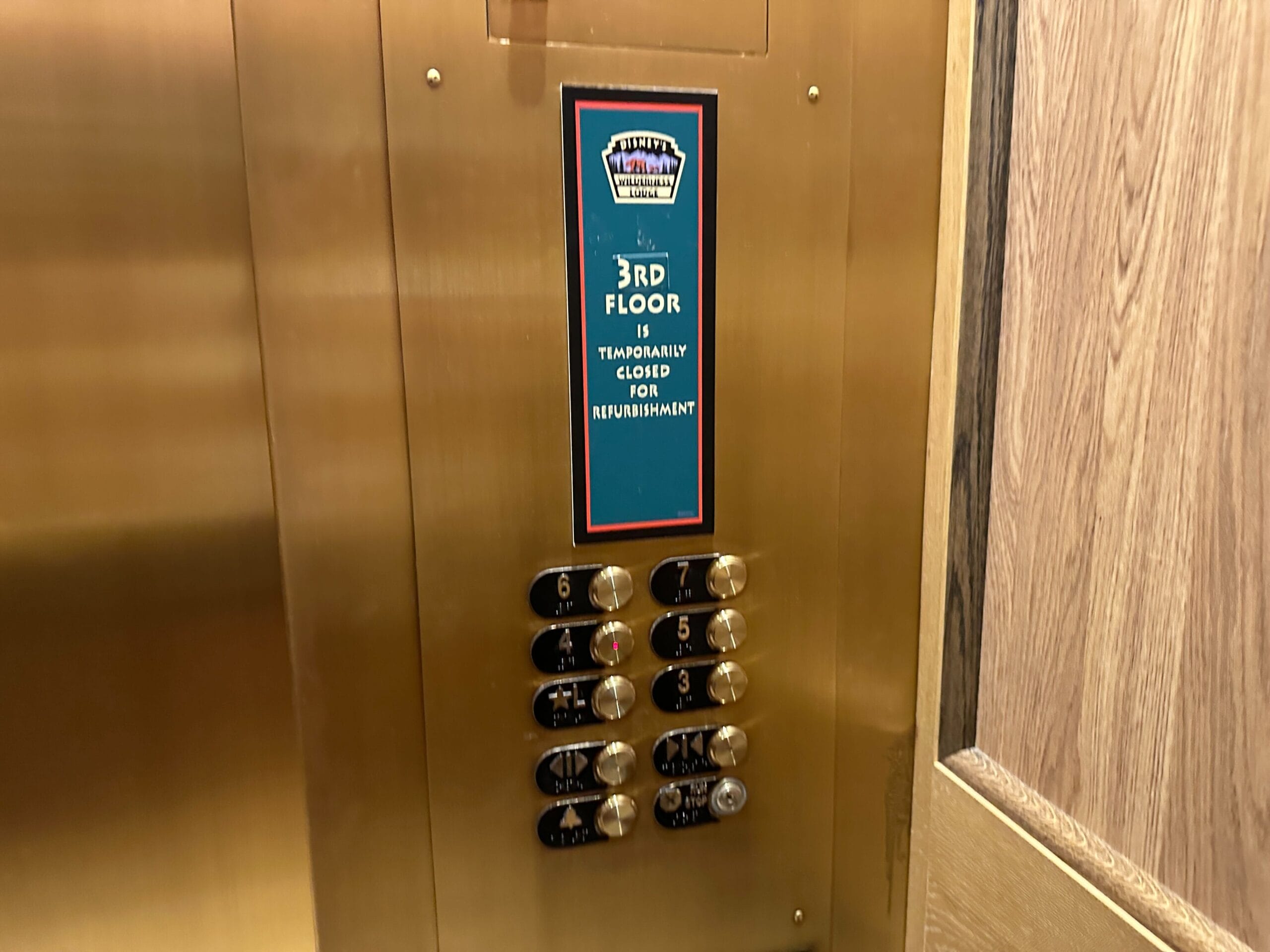 Elevator panel with a sign stating the 3rd floor is temporarily closed for refurbishment.