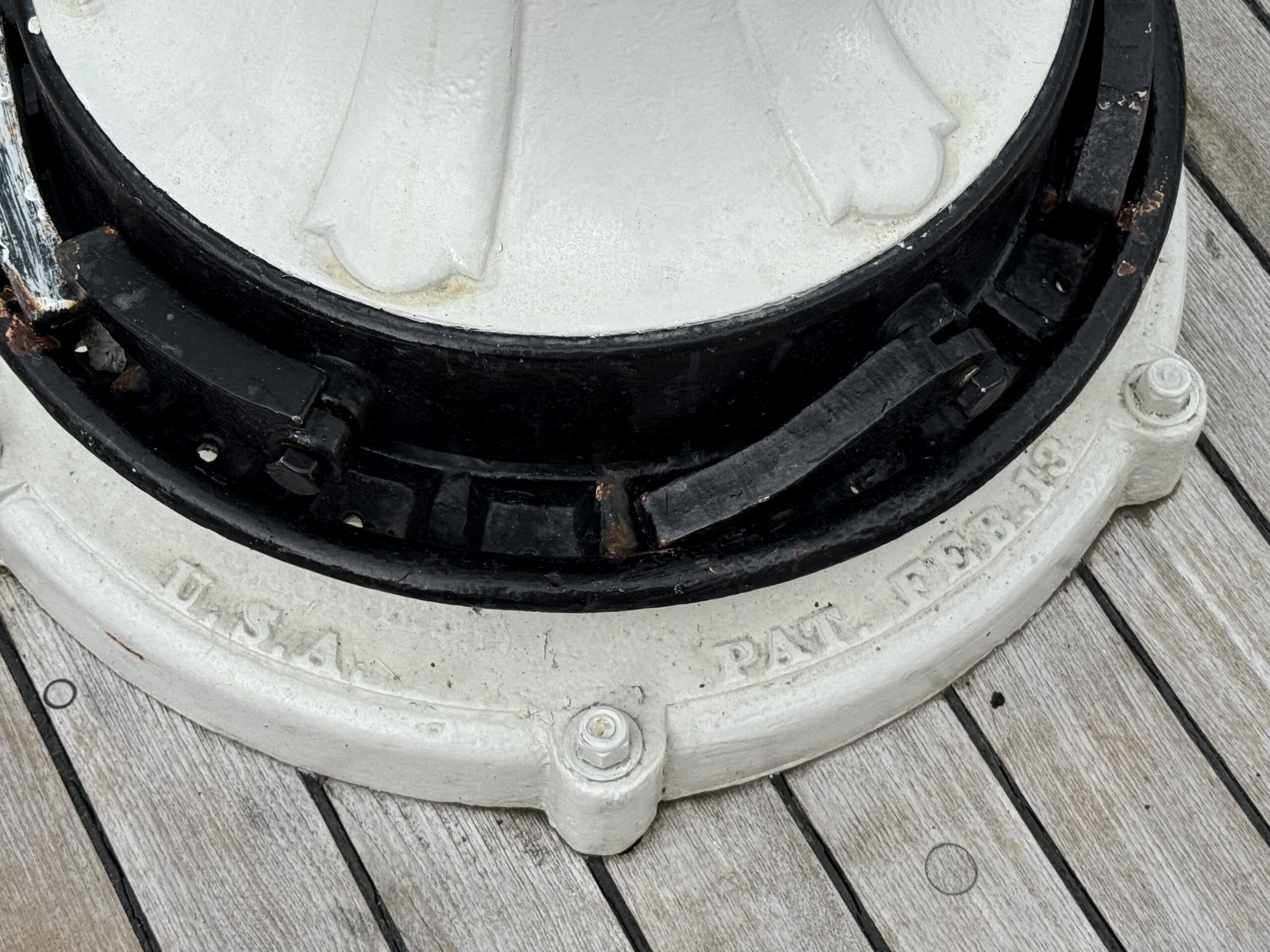 Close-up of a metal base with “U.S.A. PAT. PEN’G”, found near the Liberty Square Riverboat in Magic Kingdom.