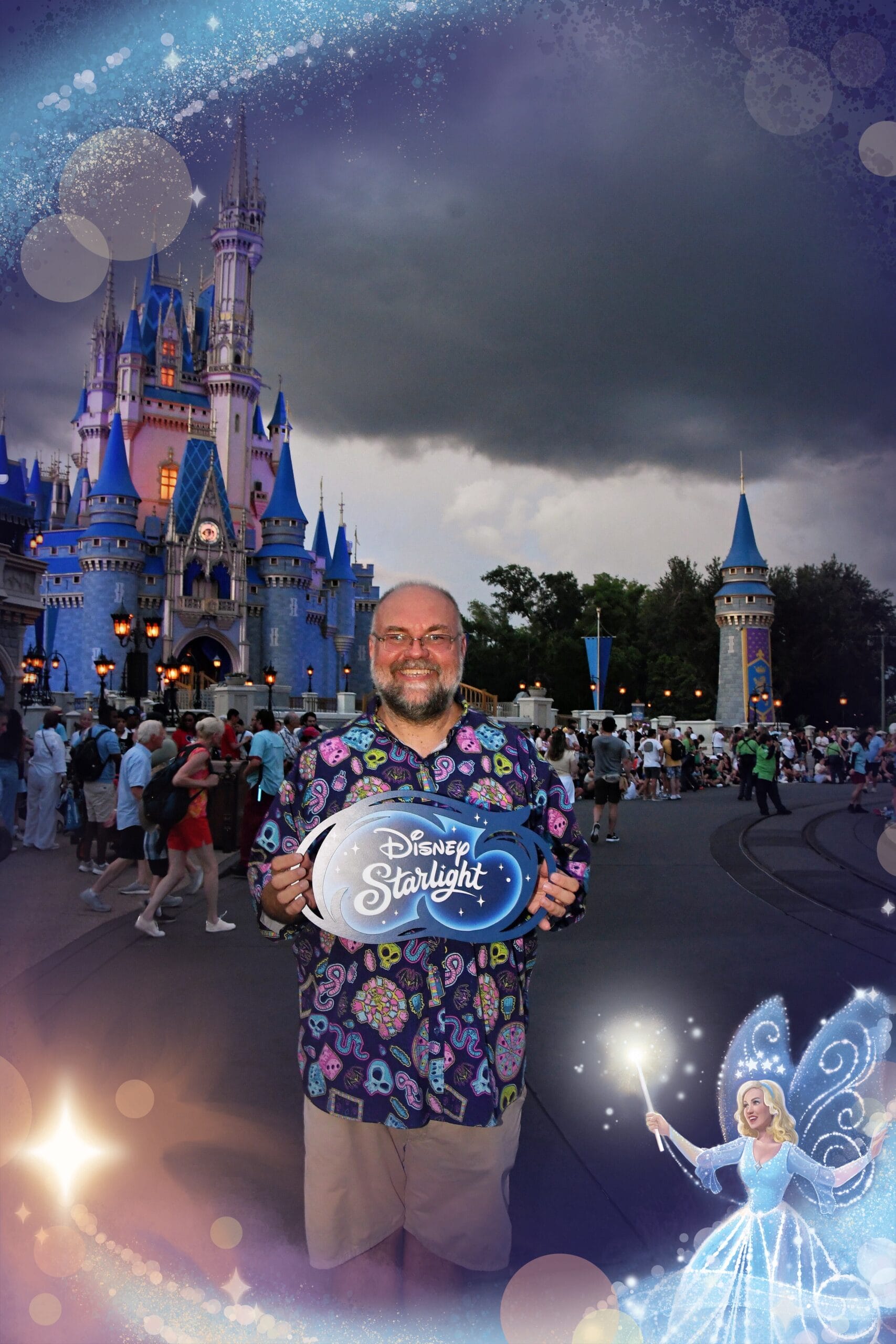 A smiling man holds a "Disney Starlight Parade" PhotoPass Prop at Cinderella Castle, with fairy tale effects and border.