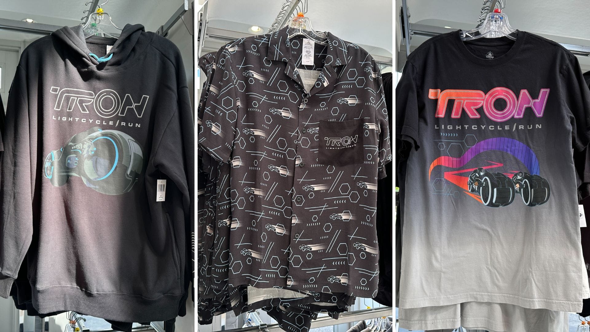 Three TRON Lightcycle Run shirts from the Apparel Collection on display at Magic Kingdom: hoodie, button-up, and tee.