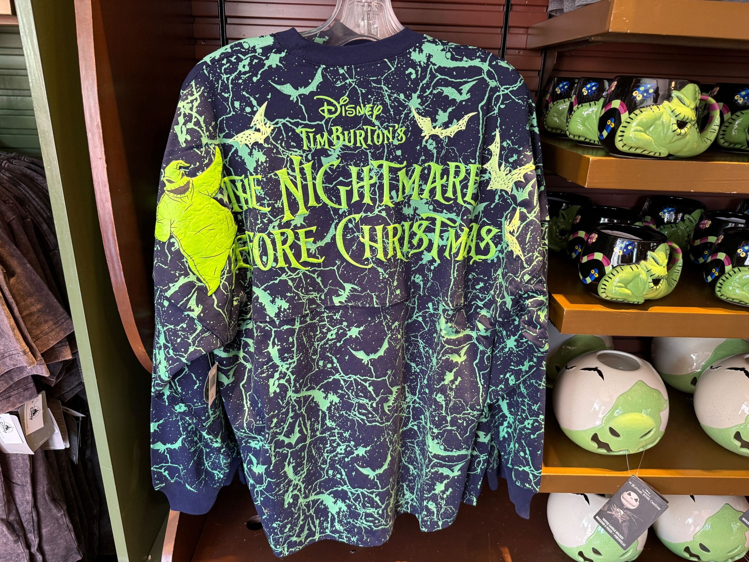 A shirt with "The Nightmare Before Christmas" text and Oogie Boogie, among themed Nightmare Before Christmas merchandise.